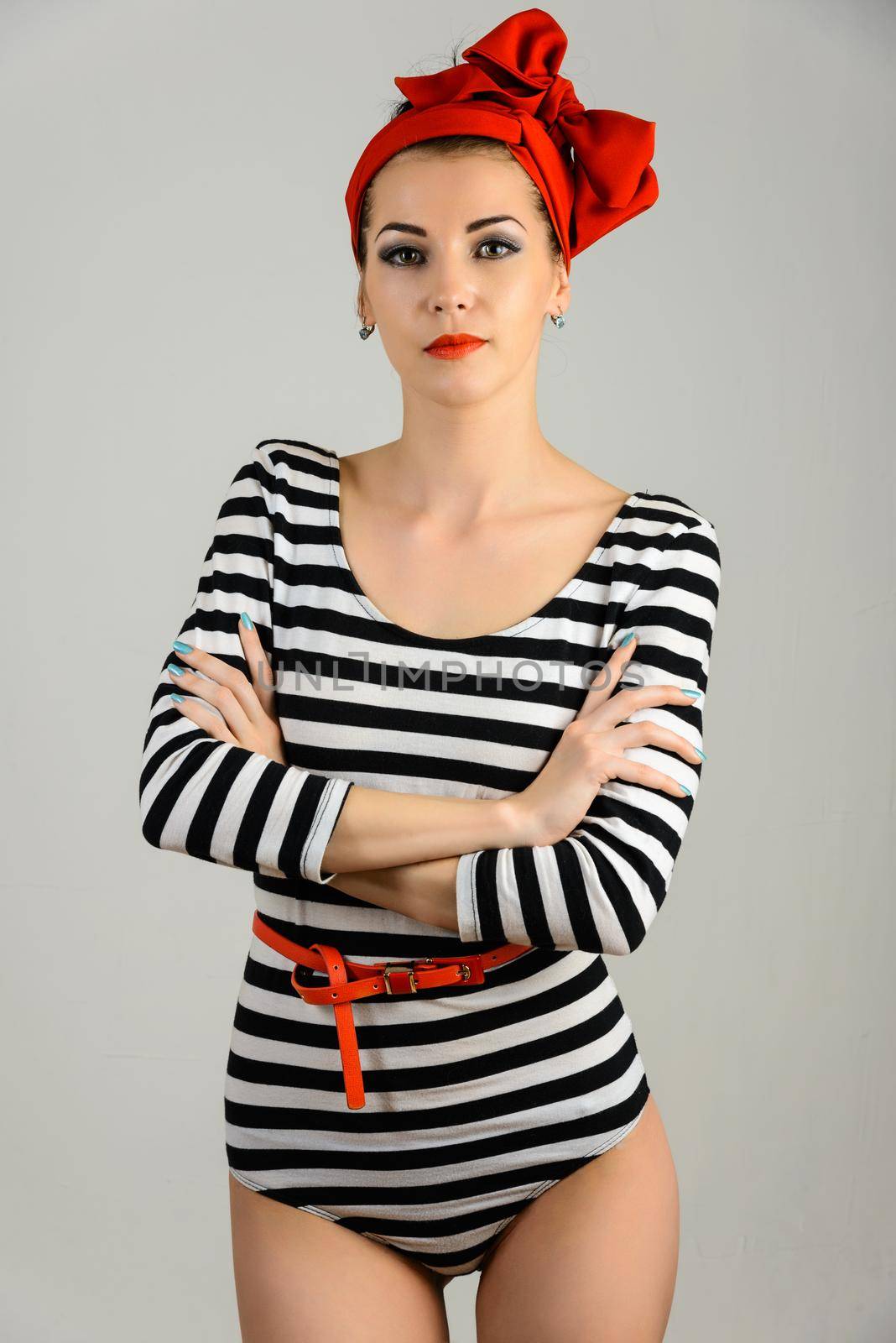 Studio portrait of a beautiful woman in sailor stripes swimsuit