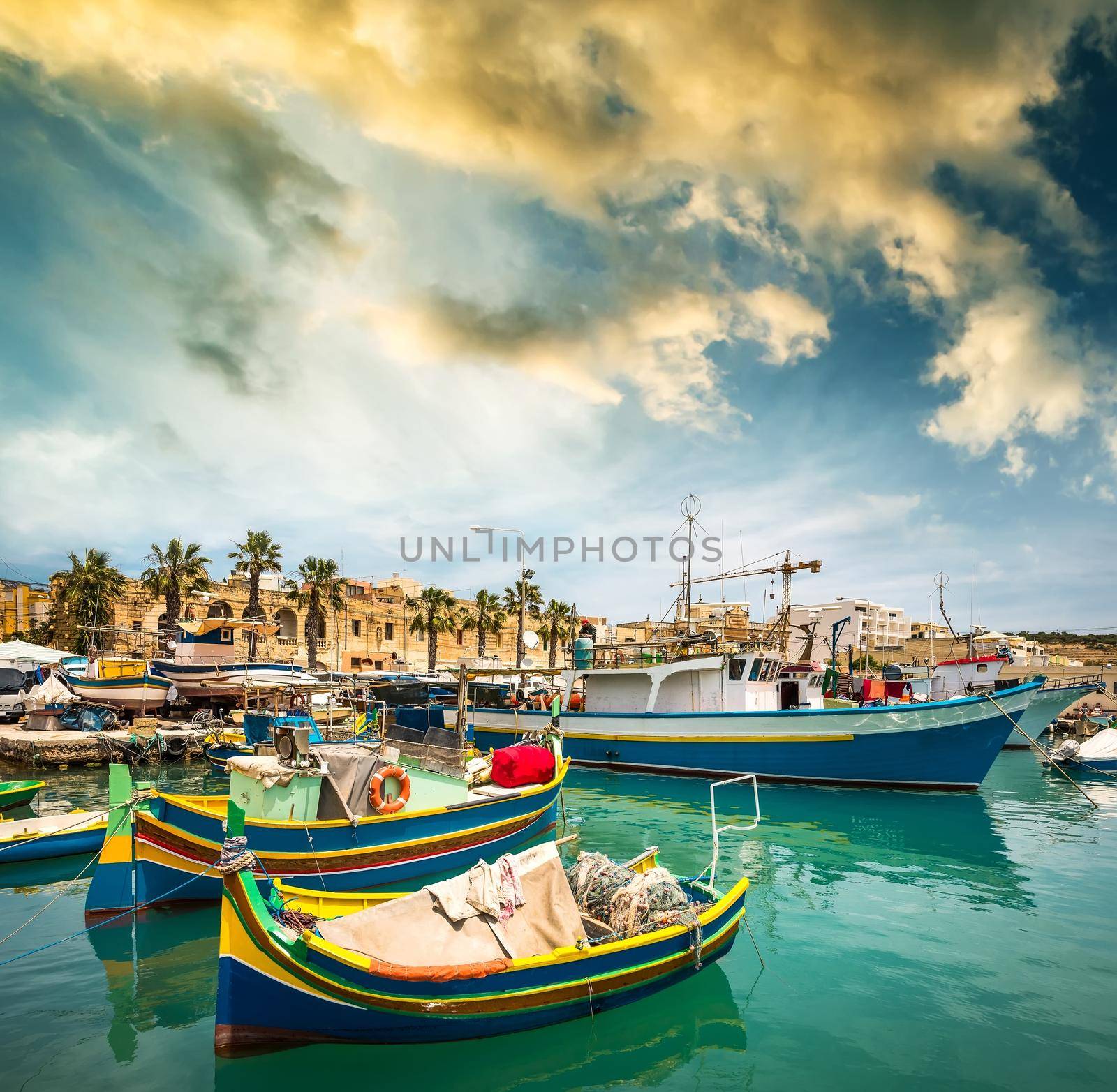 fishing boats near fishing village of Marsaxlokk in Malta in sunset
