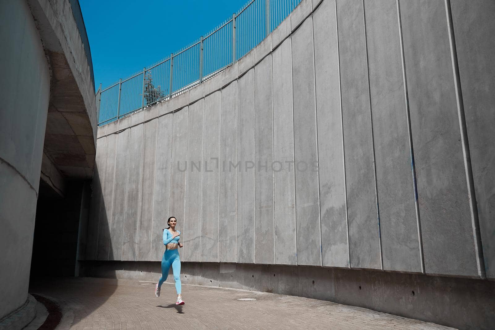 Beautiful fit young woman jogger is running outdoors by Yaroslav_astakhov