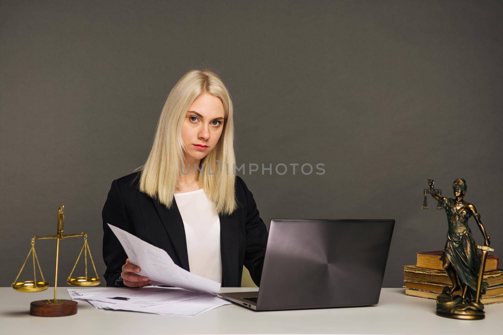 Portrait of smiling businesswoman looking at camera while working at office - image