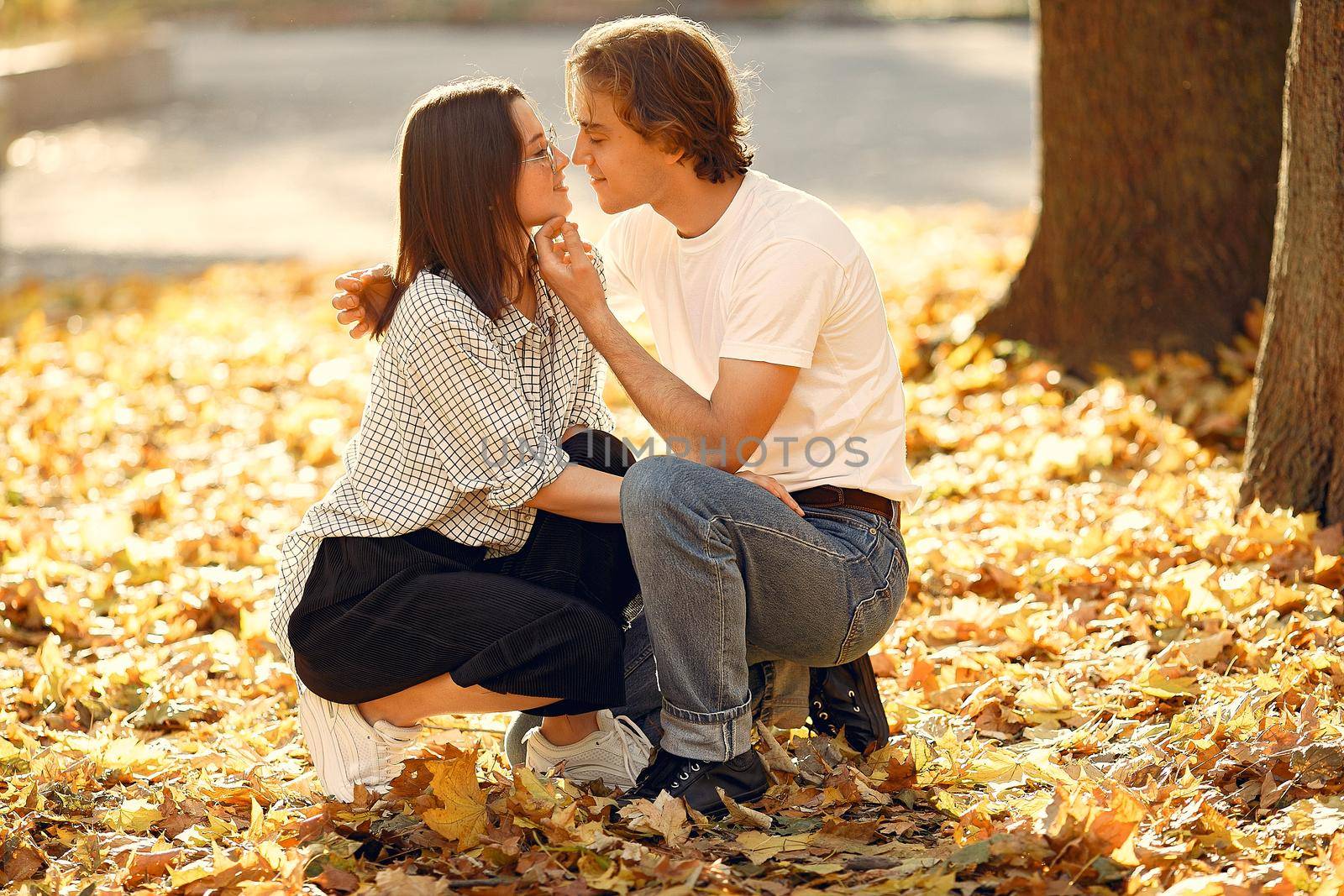 Beautiful couple spend time in a autumn park by prostooleh