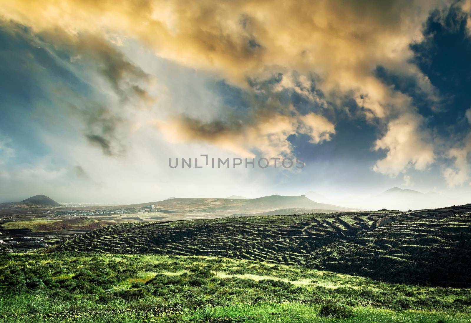 beautiful mountain landscape with green field against sunsut sky in Lanzarote, Canary Islands