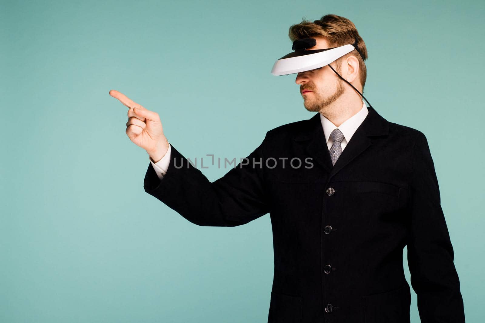 Businessman in a formal wear wearing virtual reality glasses pointing fingers away by zartarn