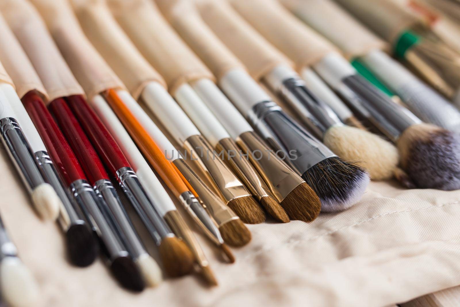 beauty and cosmetics concept - Set of make-up brushes in a light case.