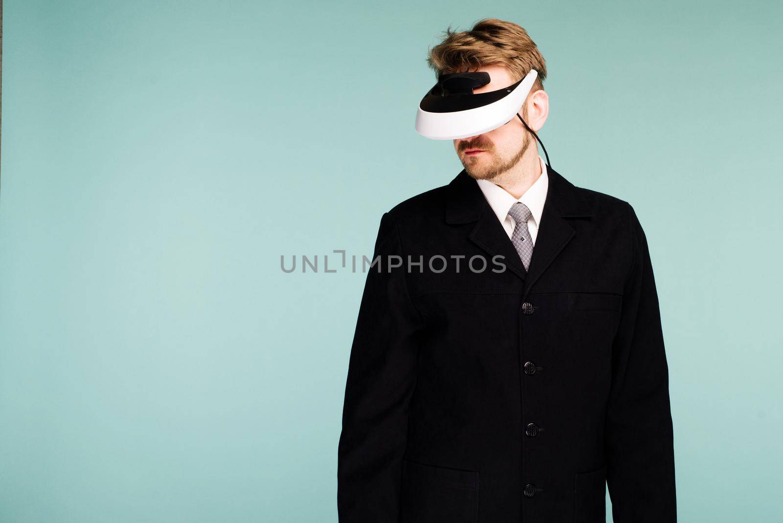 Businessman in a formal wear wearing virtual reality glasses - image