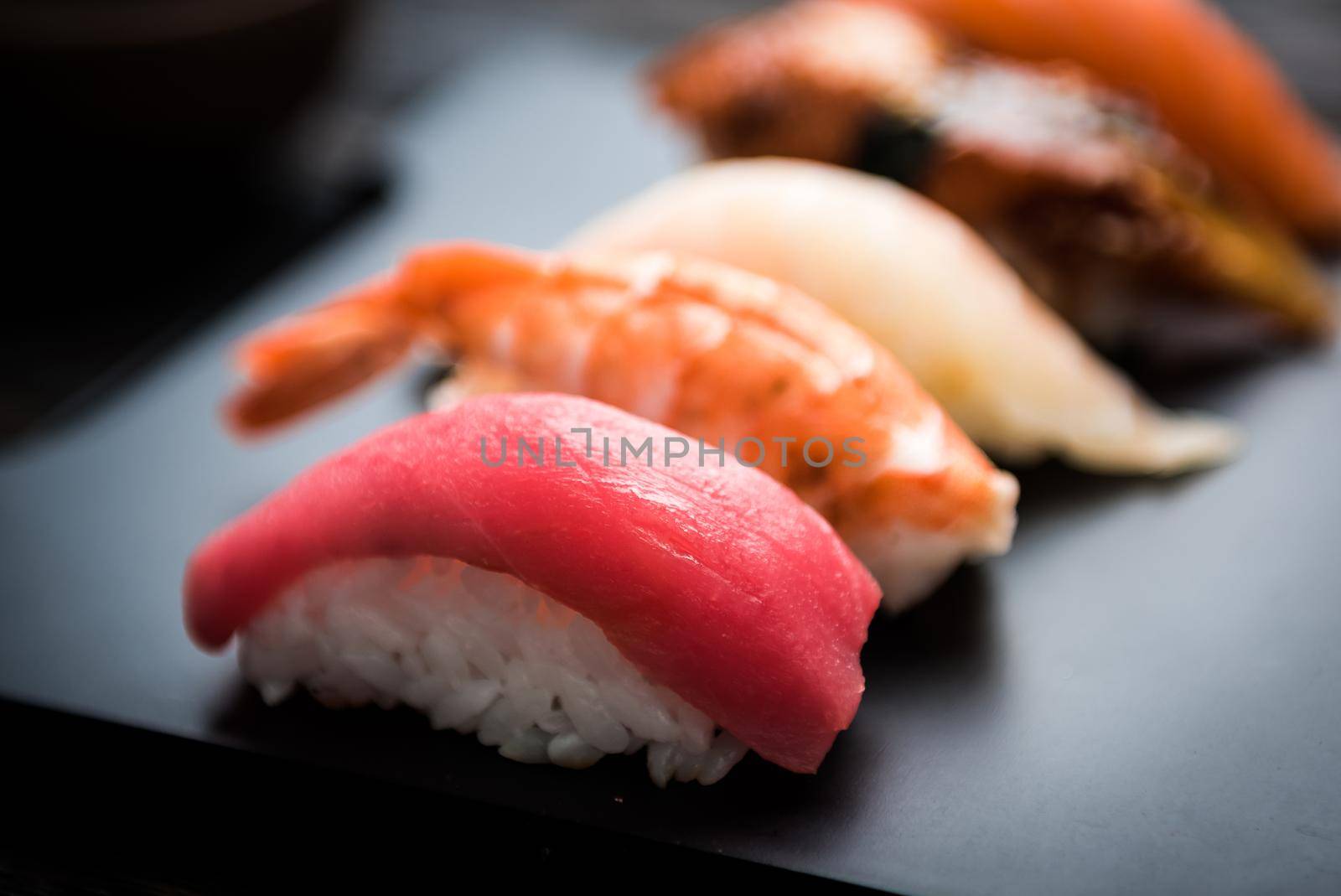 close up of sashimi sushi set on black tray