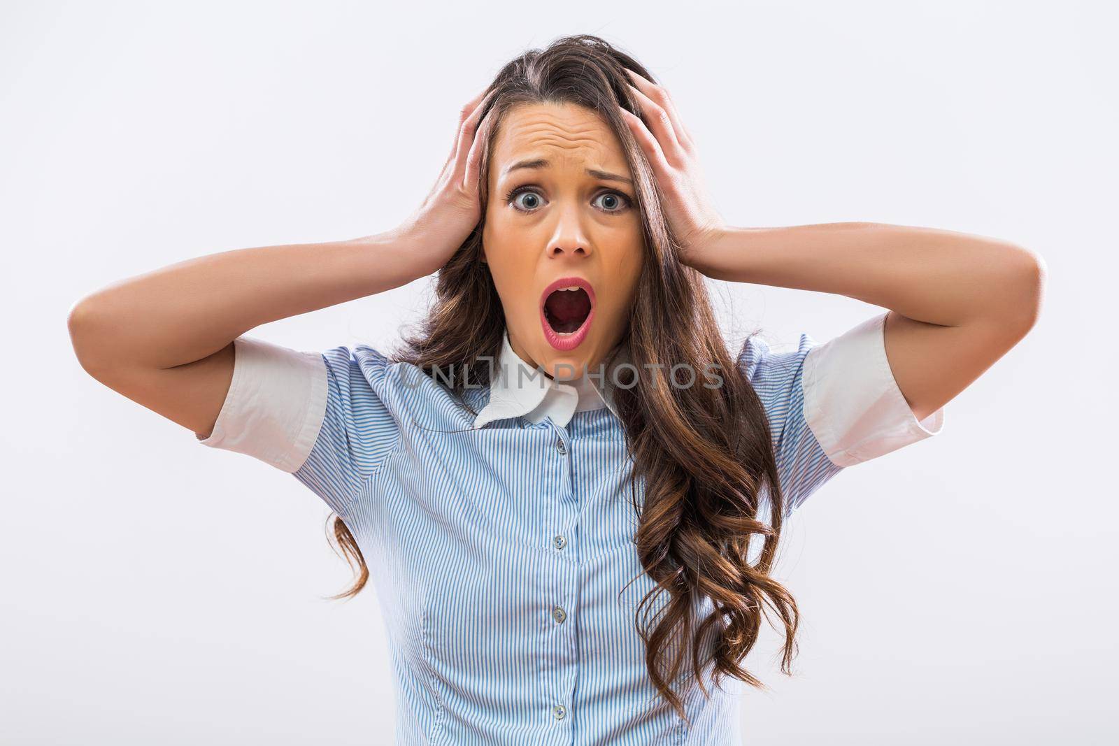 Image of businesswoman in panic on gray background.