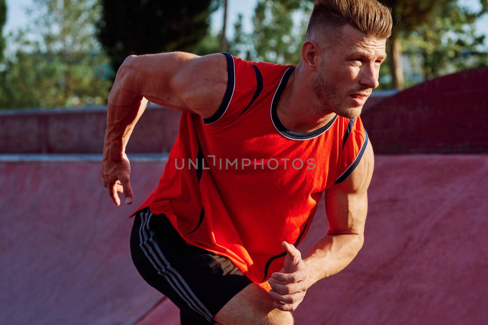 man doing exercises outdoors in the park by Vichizh