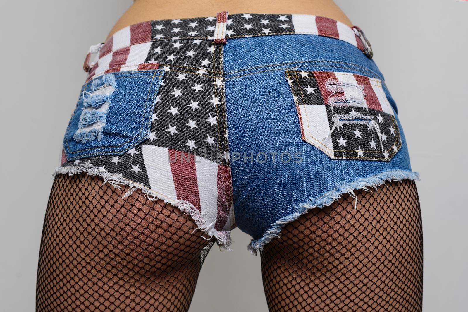 Beautiful female ass in USA shorts. Isolated on white background.