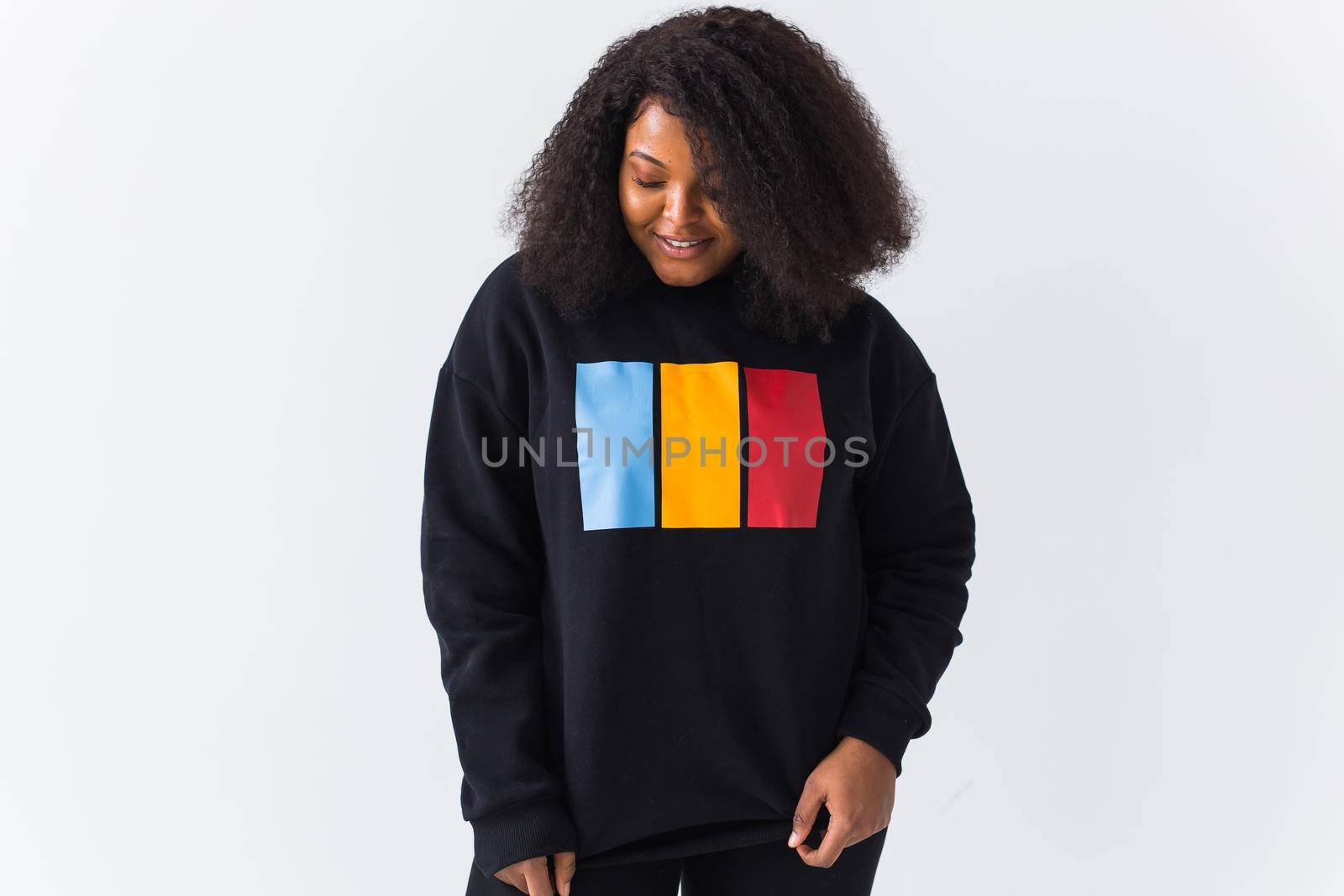 Youth fashion concept - Portrait of confident sexy black woman in stylish hoodie on white.