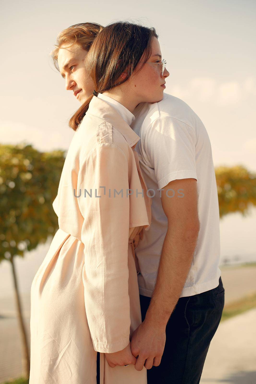 Couple in a summer park. Man in a white t-shirt.