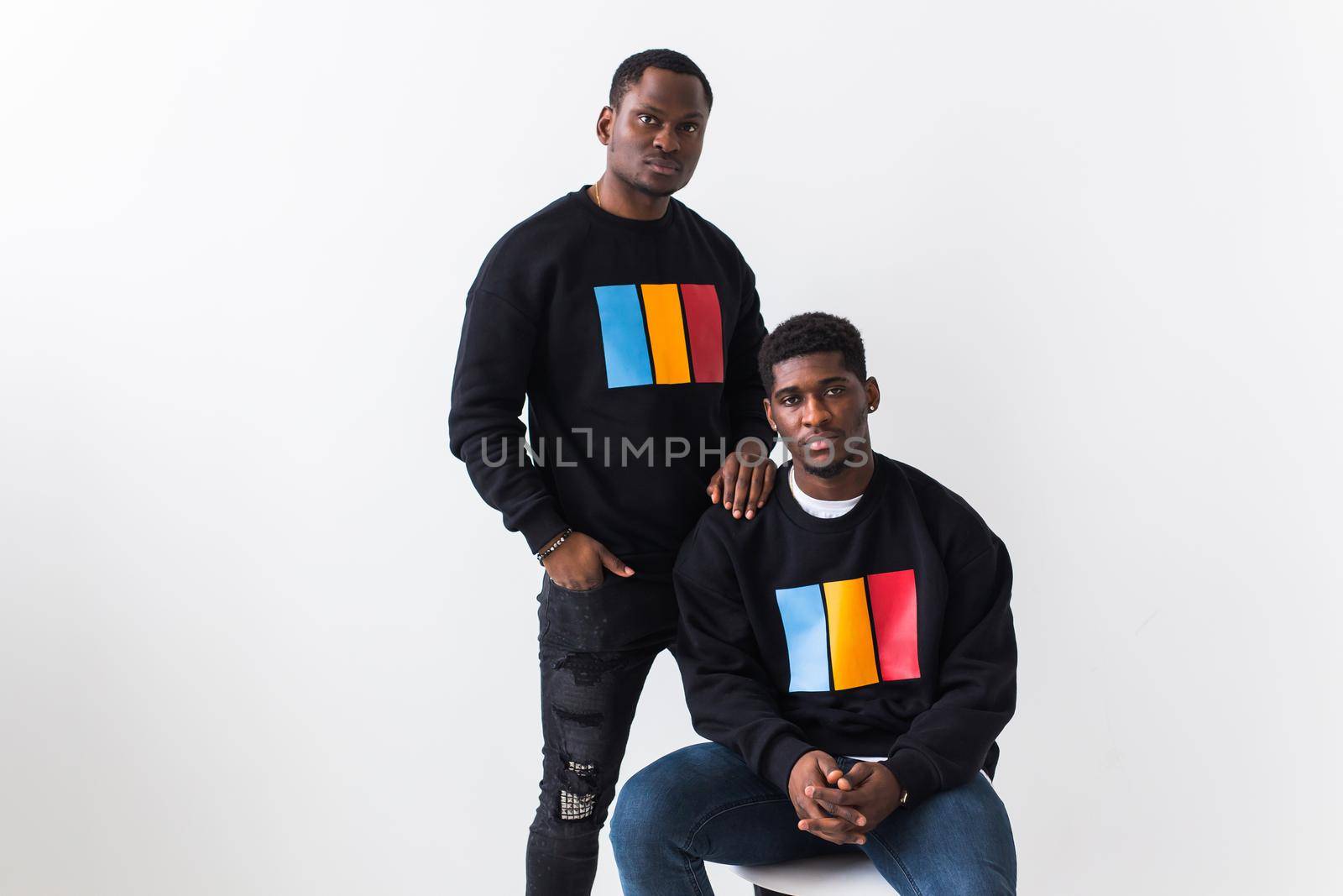 Street fashion and friendship concept - Two happy african american young men in black stylish sweatshirts