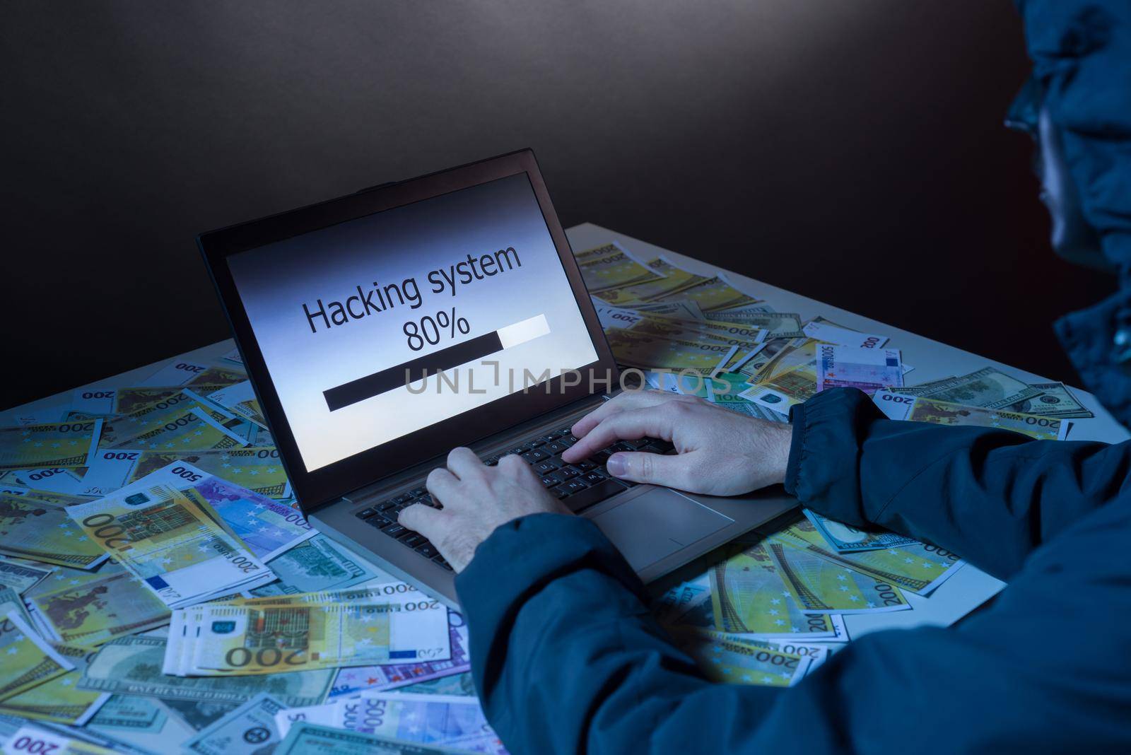 Anonymous hacker programmer uses a laptop to hack the system in the dark. Creation and infection of malicious virus. The concept of cybercrime and hacking database by zartarn