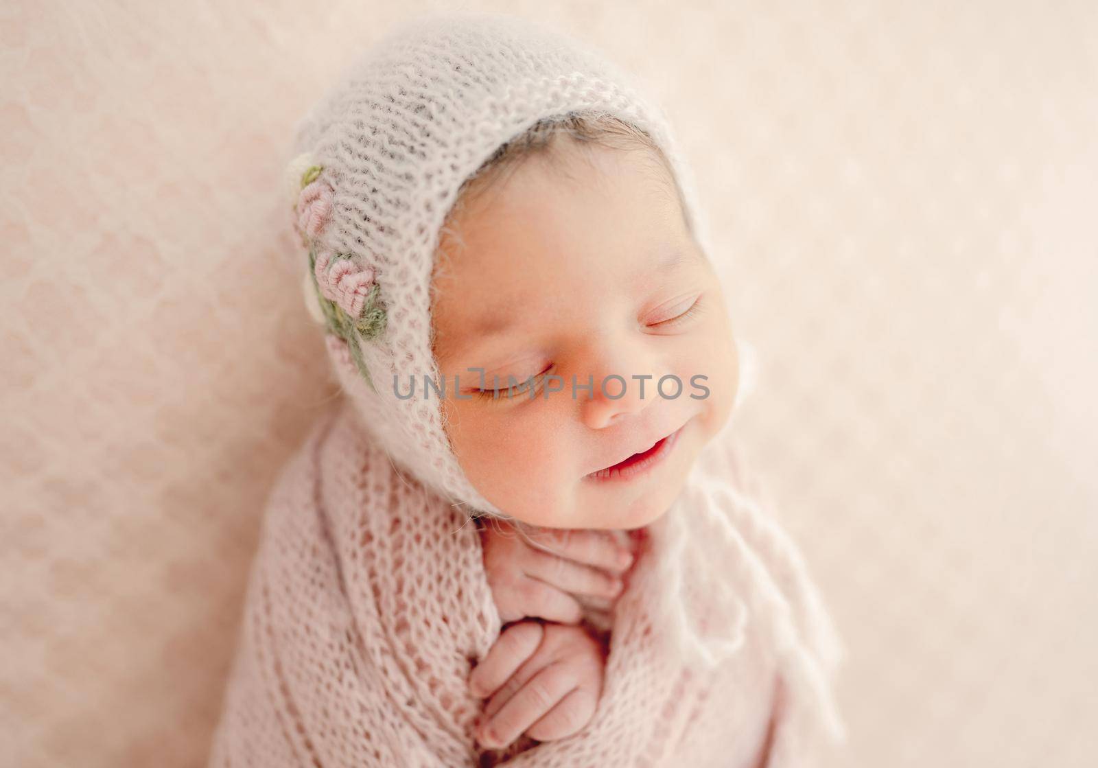 Adorable newborn baby girl sleeping portrait. Cute infant kid child napping wearing hat