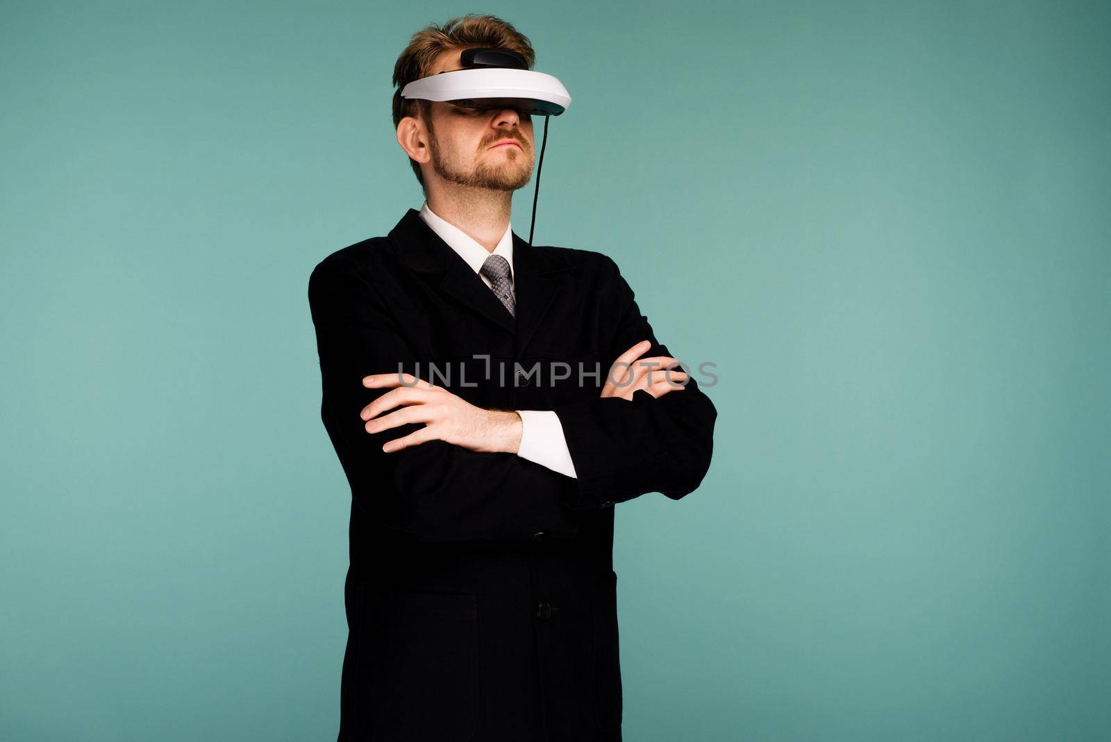 Businessman in a formal wear wearing virtual reality glasses - image