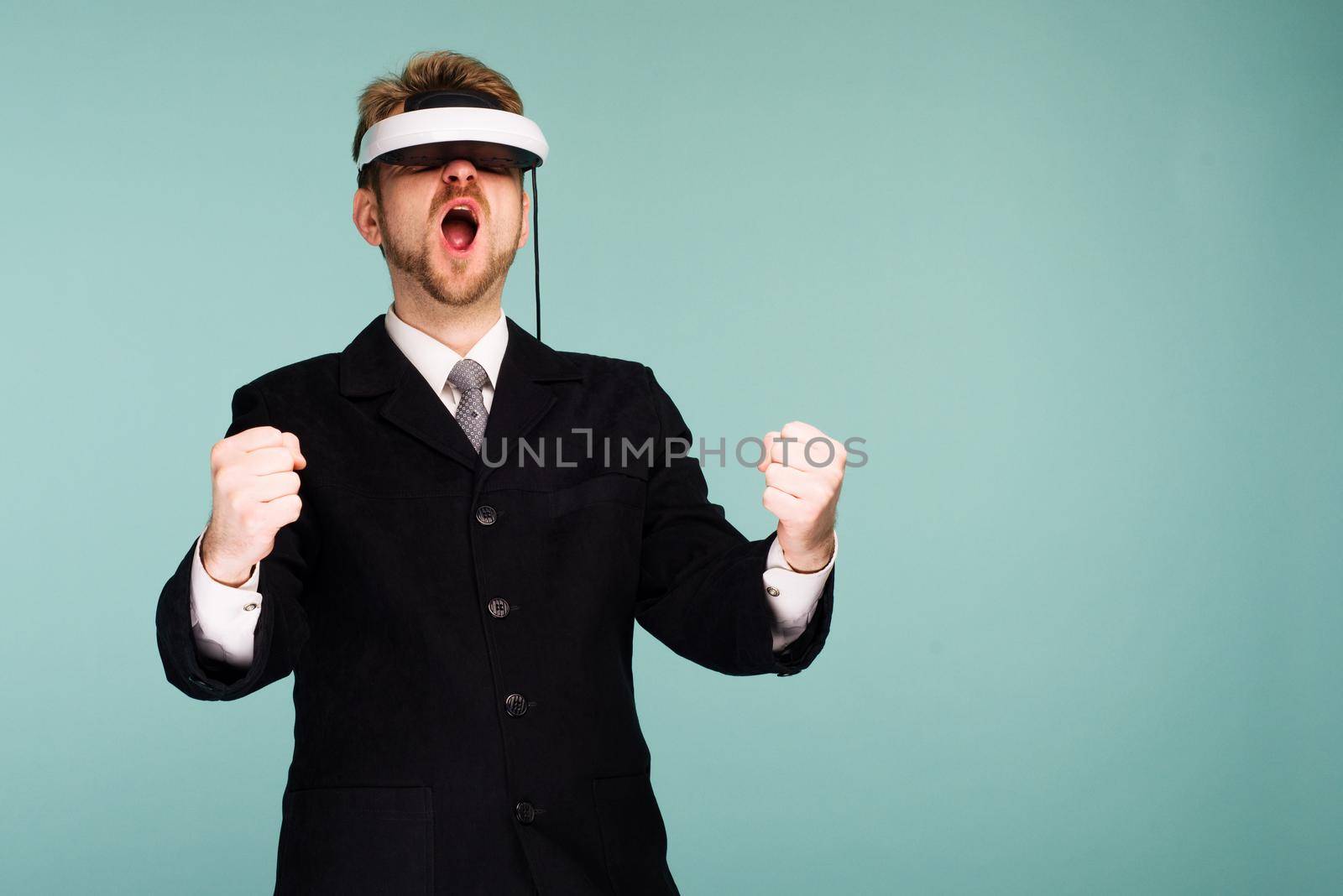 Businessman in a formal wear wearing virtual reality glasses holding a virtual steering wheel by zartarn