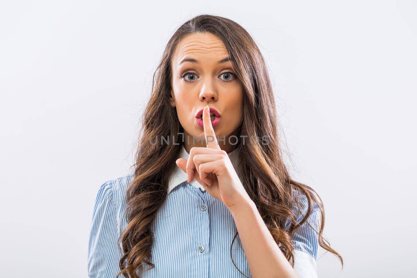 Beautiful businesswoman showing silence sign by Bazdar