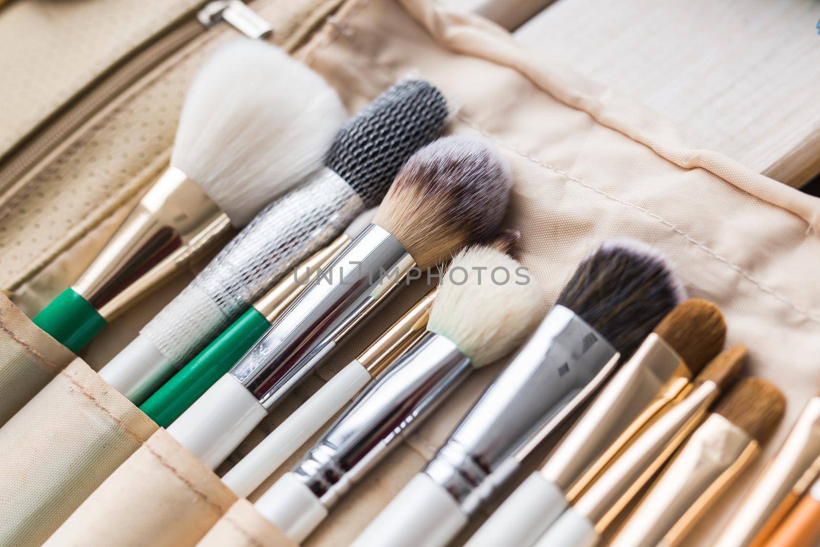 Makeup, beauty and cosmetics concept - Set of make-up brushes in a light case. by Satura86