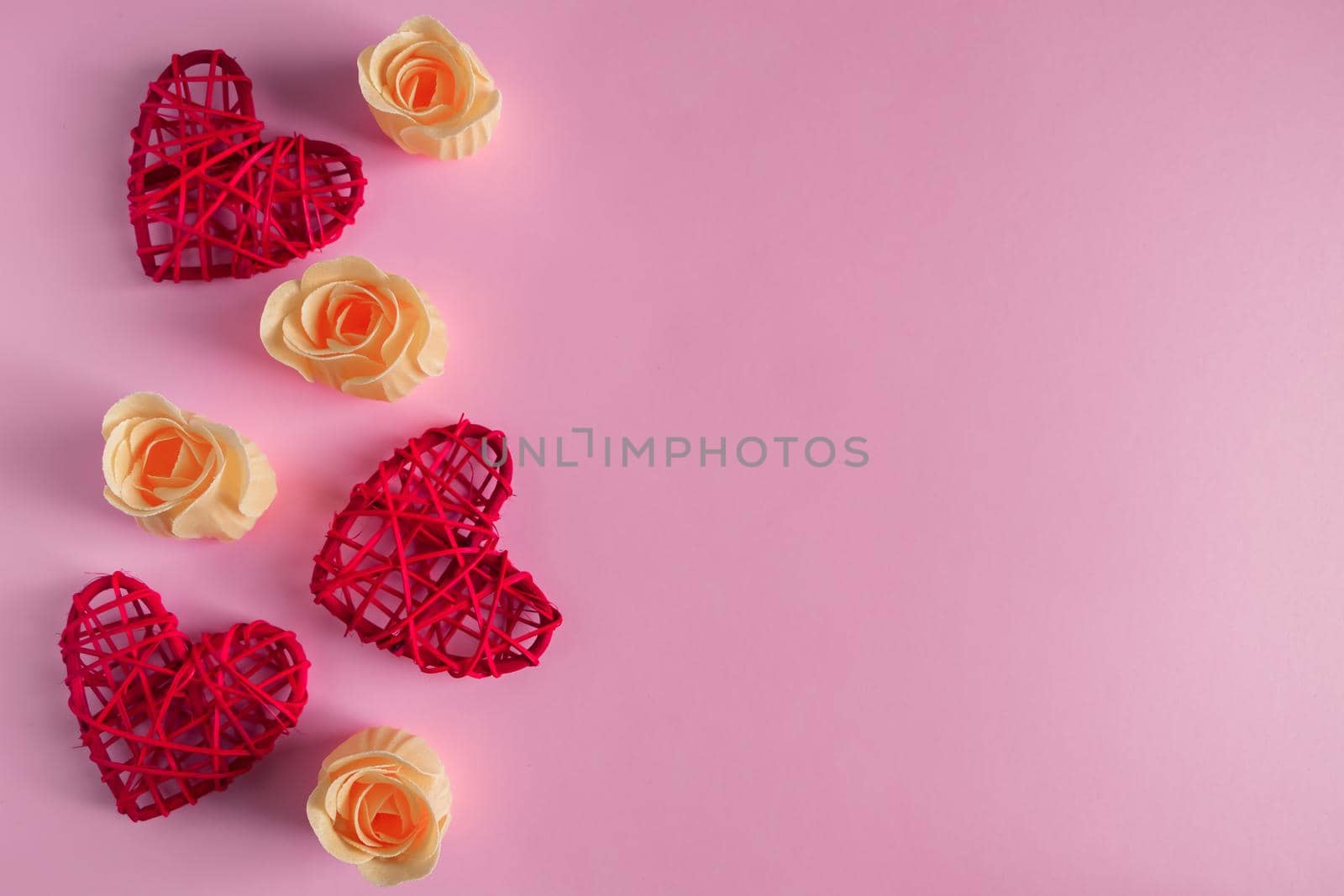 Red hearts and rosebuds on a pink background, concept for Valentine's Day. by Statuska