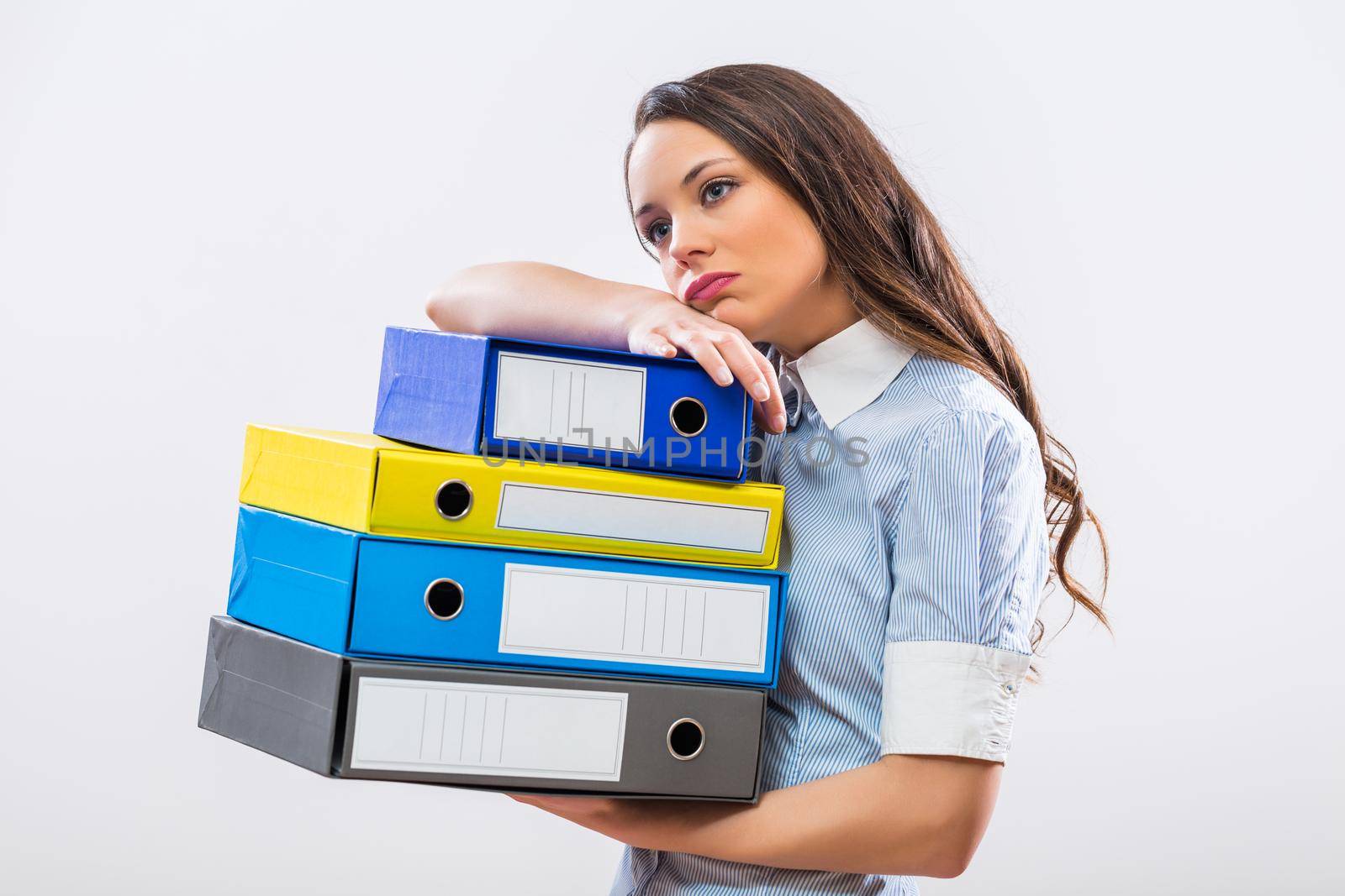 Tired businesswoman holding office archives by Bazdar