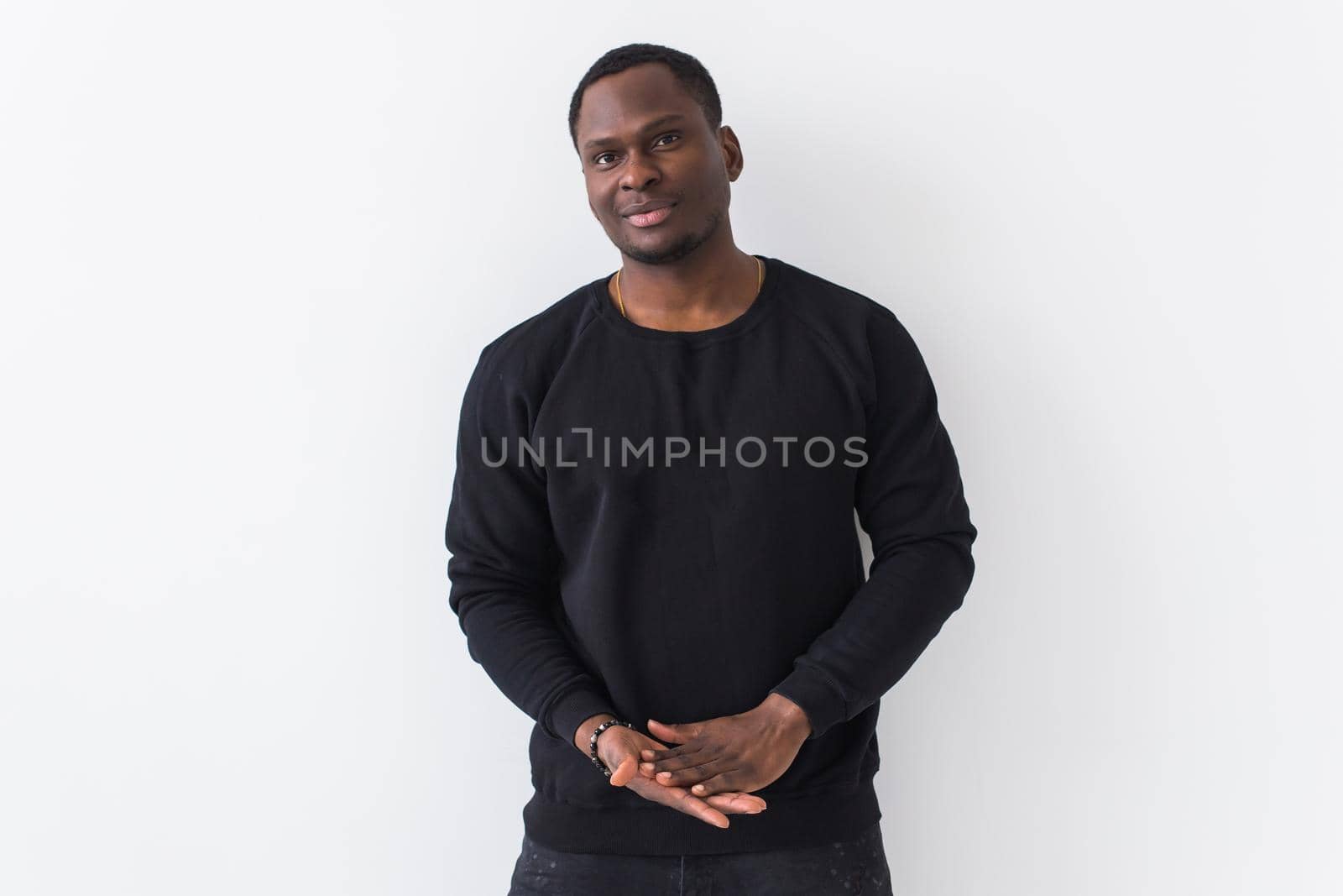 Young handsome african american man with an afro hairstyle. Portrait on white background. Guy looking at camera