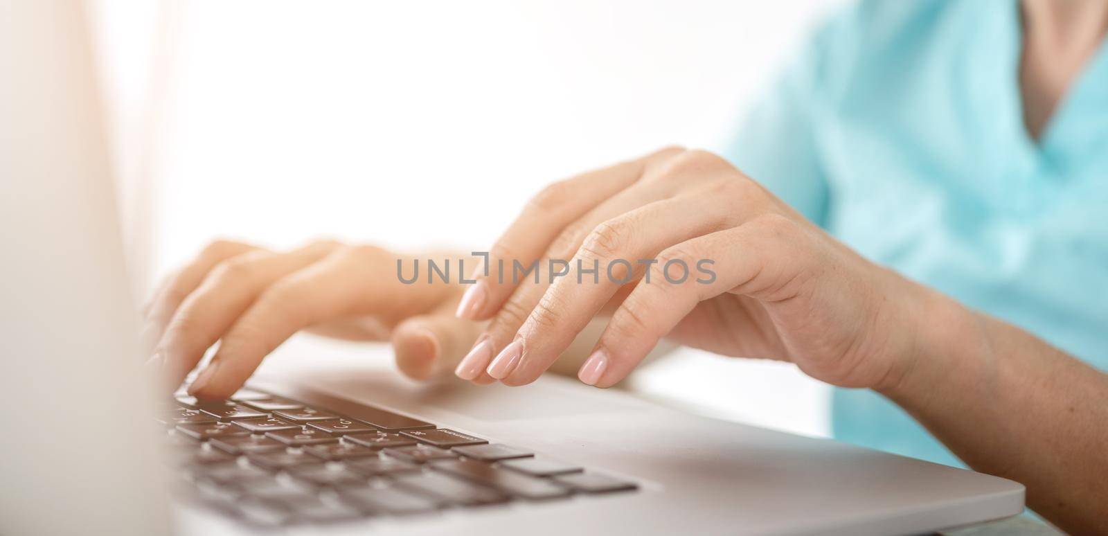 Girl hands typing on laptop keyboard closeup view. Female woman person working with computer