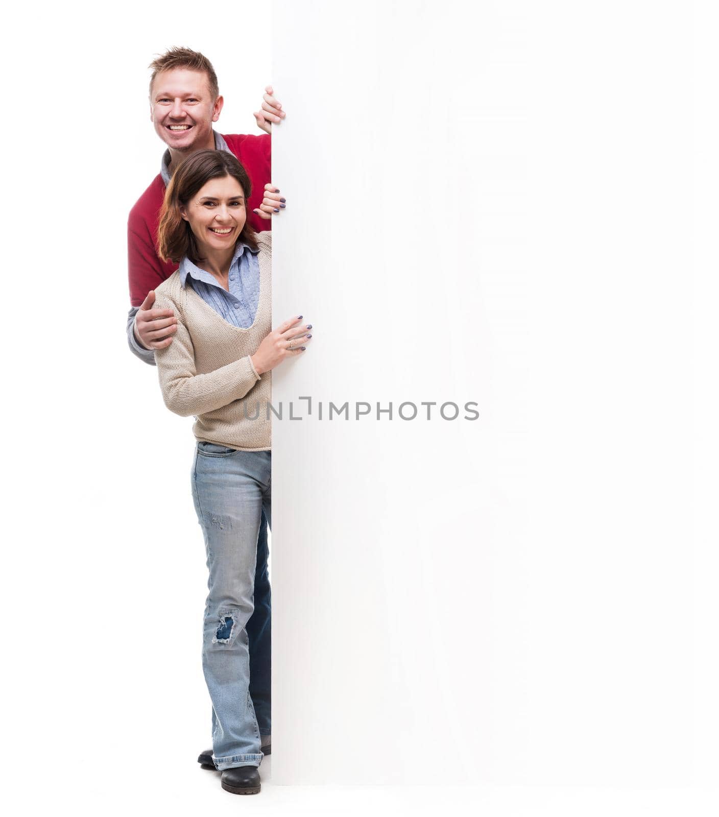 couple peek out from behind empty blank isolated on white background