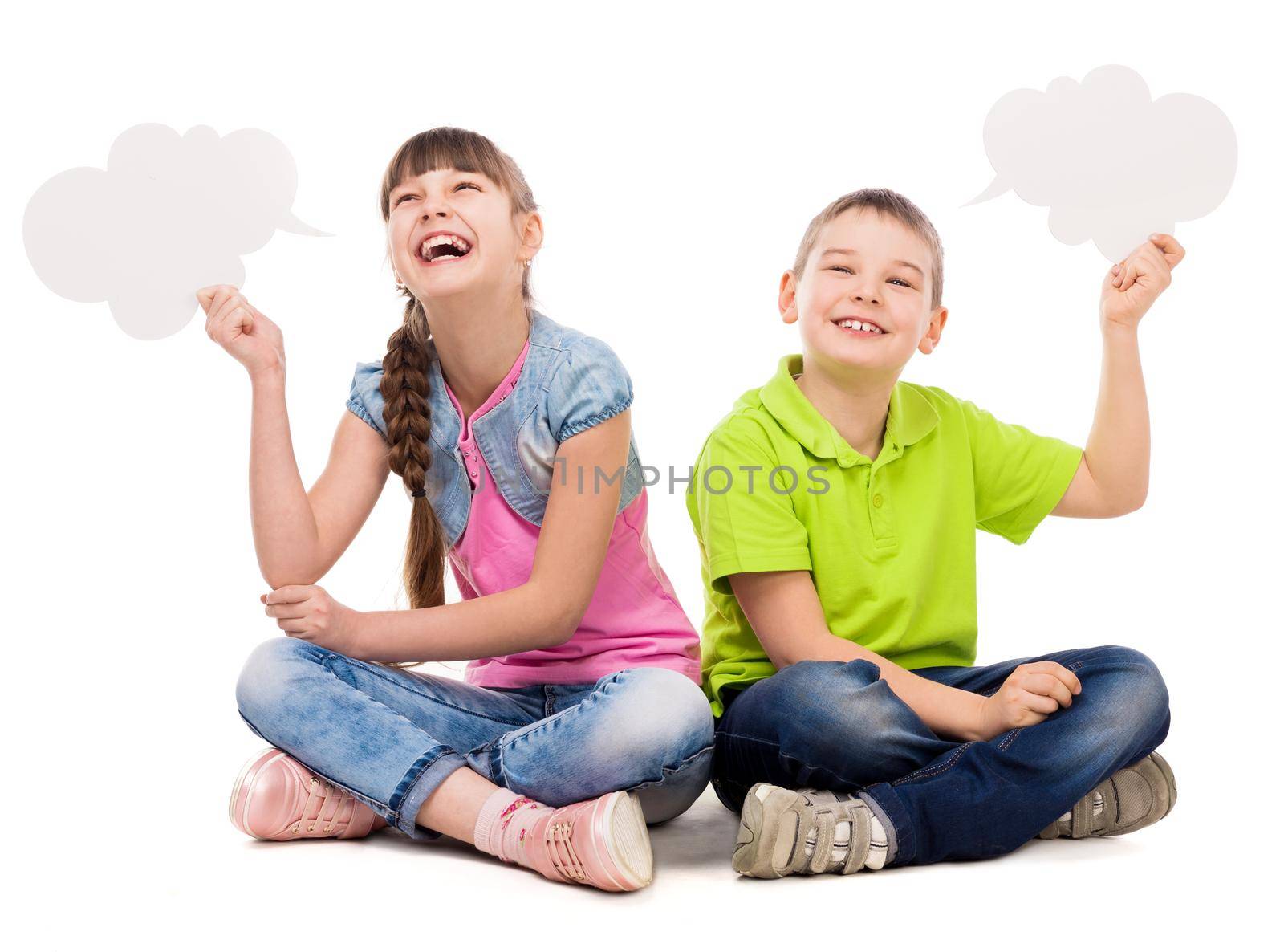 two funny children sitting on the floor with paper clouds in hands laughing isolated on white background