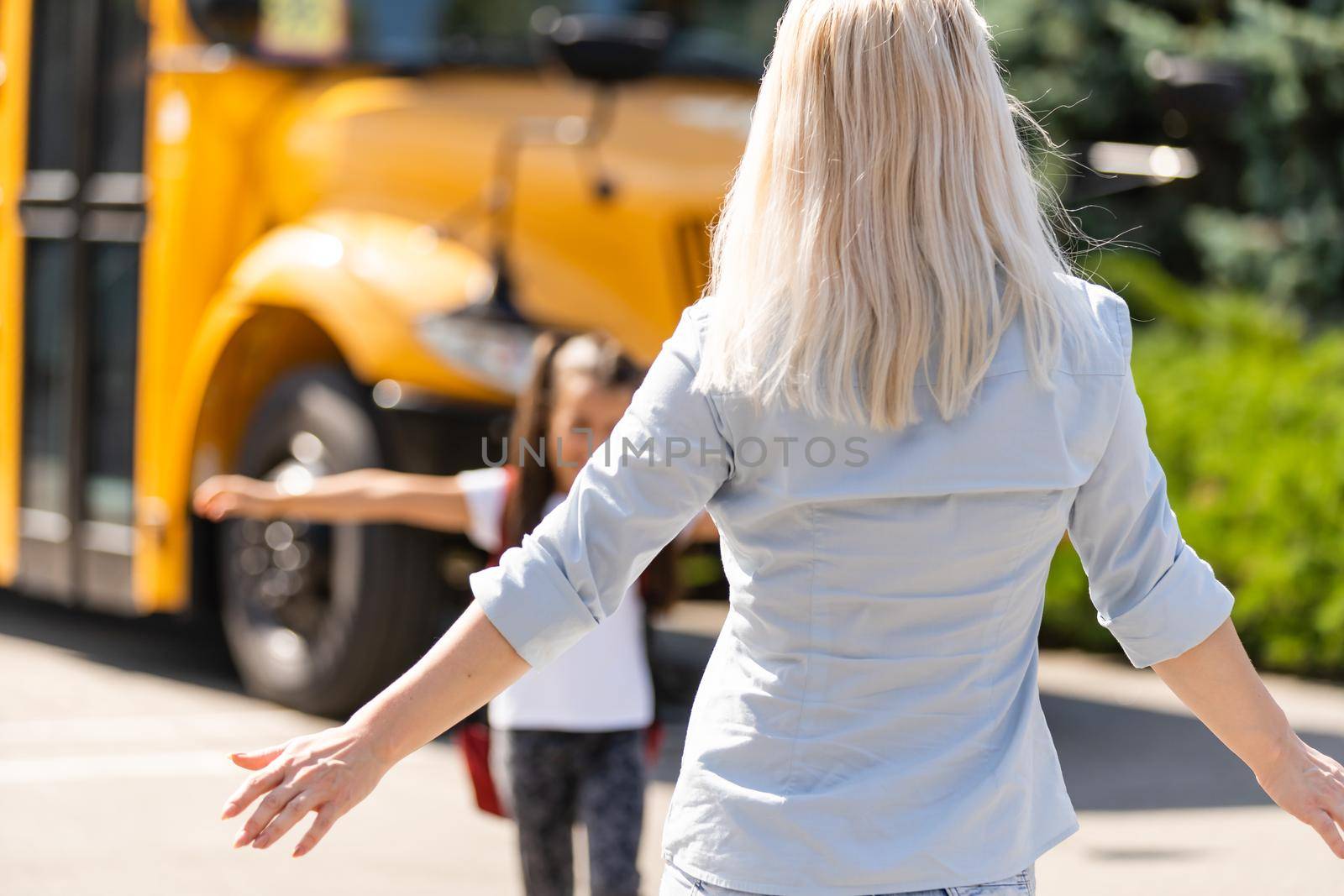 Beautiful small girl with mother near school by Andelov13