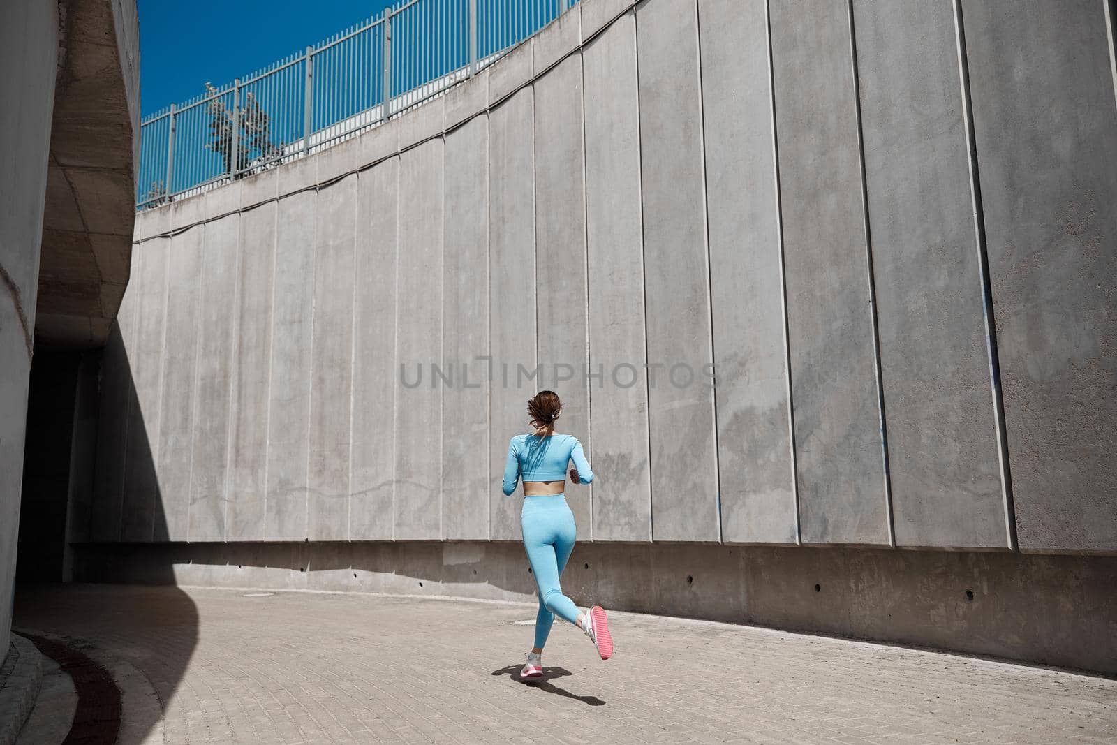 Beautiful fit young woman jogger is running outdoors by Yaroslav_astakhov