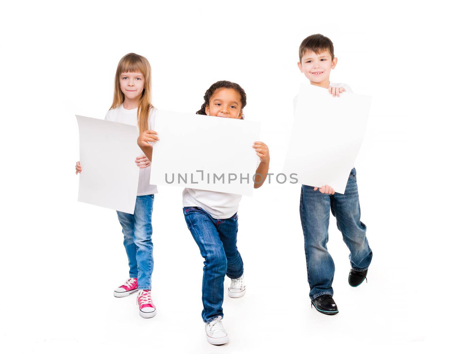 three funny children holding paper blanks in hands isolated on white background