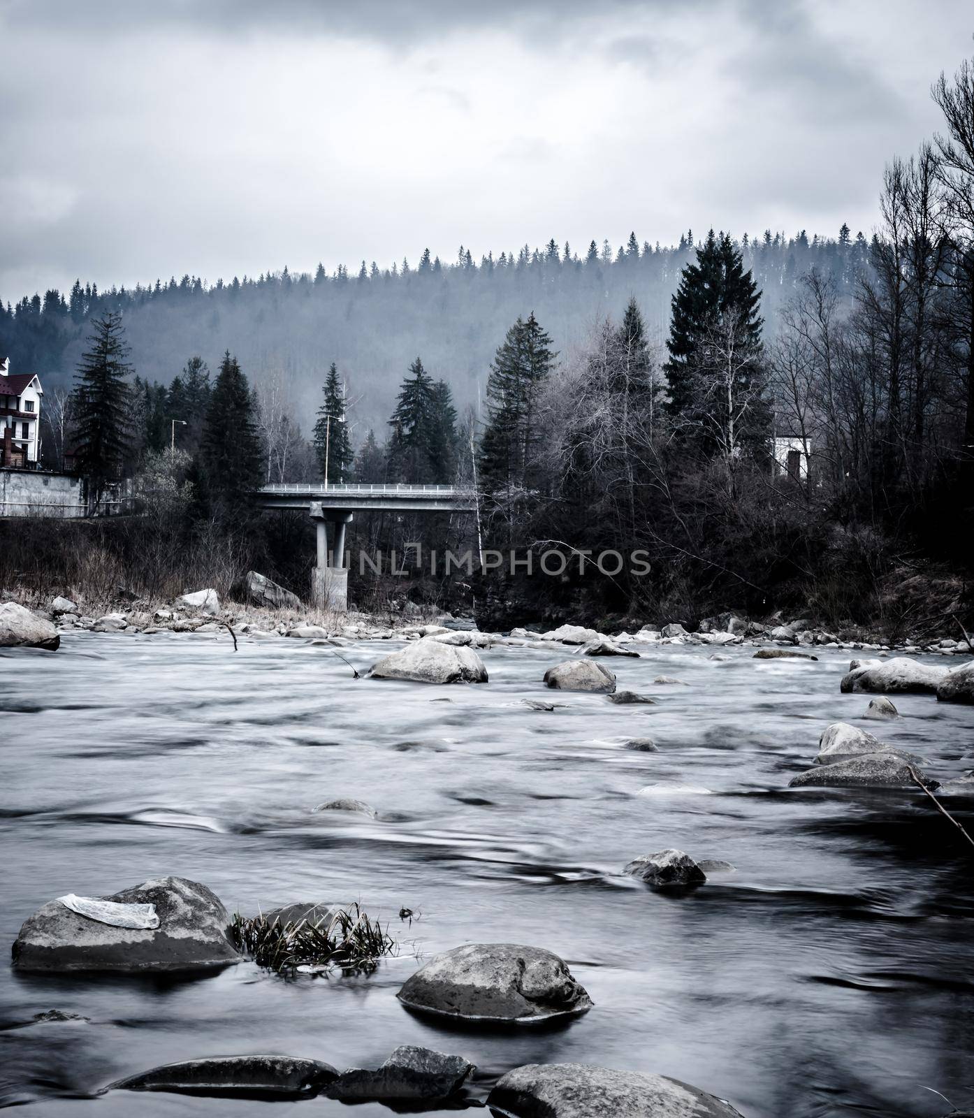 beaytiful mountain landscape with river in Carpathian mountains in grey colors