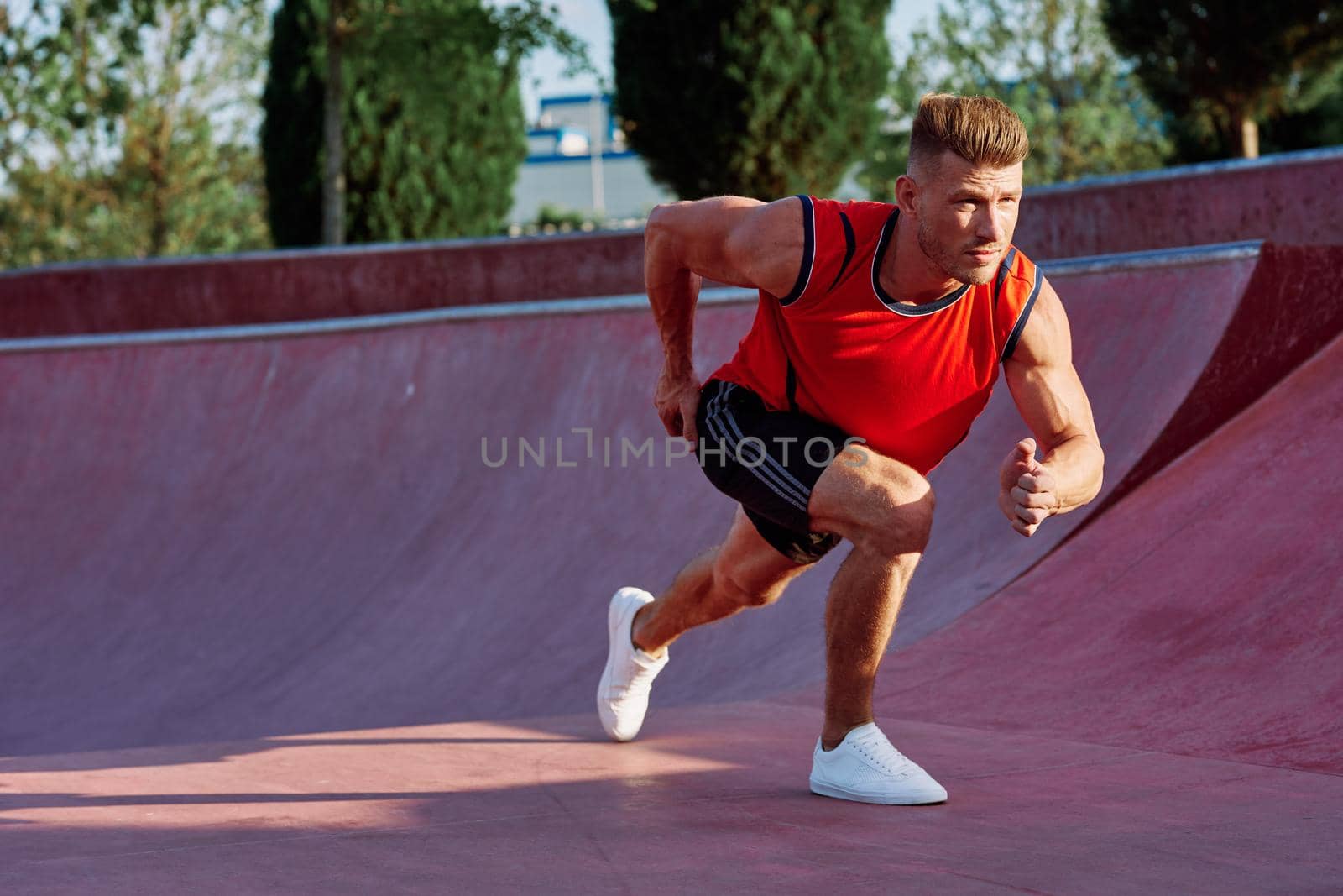 man doing exercises outdoors in the park by Vichizh