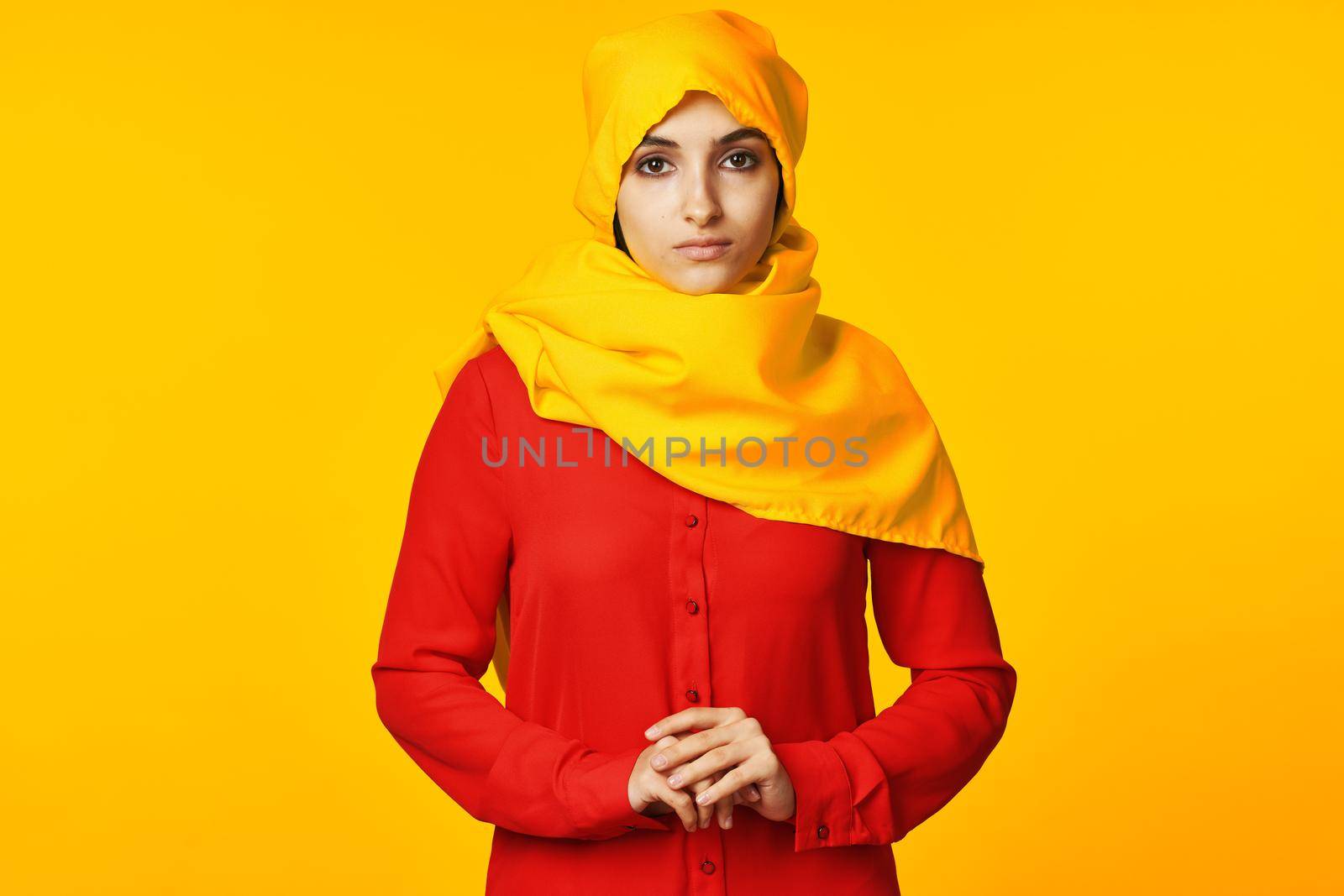 muslim woman wearing yellow hijab posing ethnicity yellow background. High quality photo