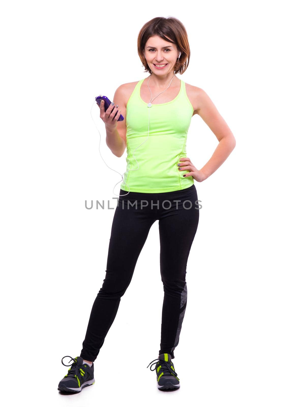 beautiful sport girl with mobile and earphones with her hand on side isoalted on white background