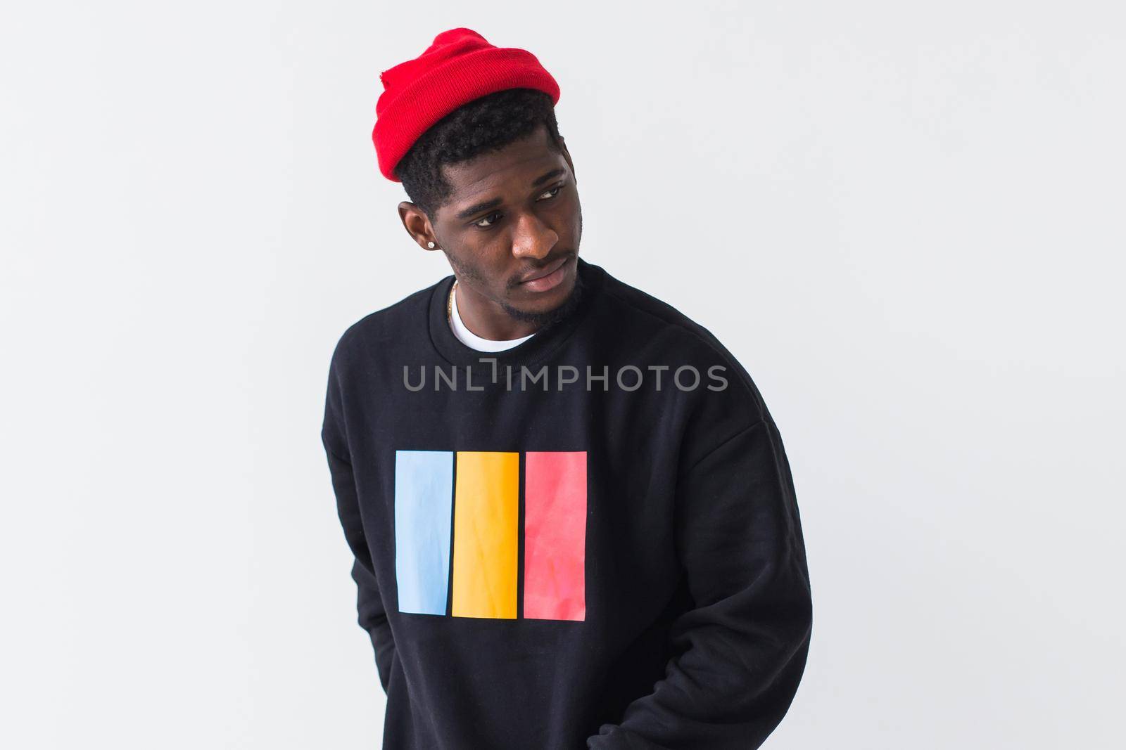 Portrait handsome young black man dressed in jeans and hoodie on white background. Street fashion and modern youth culture