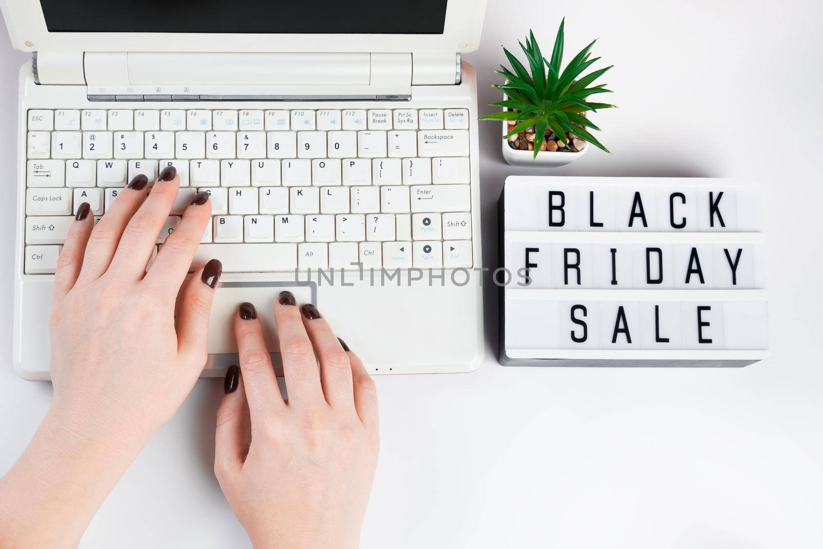 Black friday sale concept. Woman buys online using a laptop.