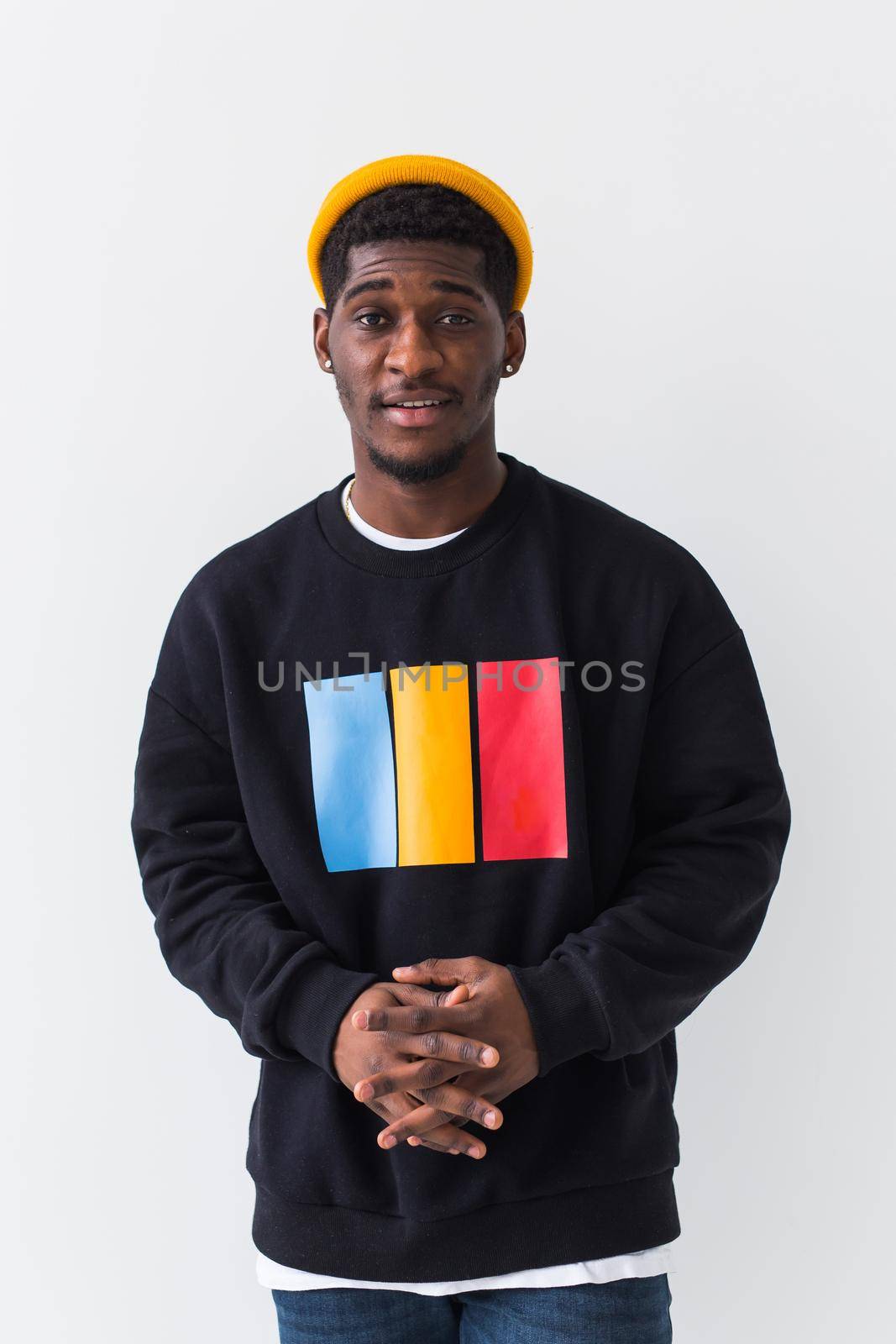 Street fashion concept - Studio shot of young handsome African man wearing sweatshirt against white background. by Satura86