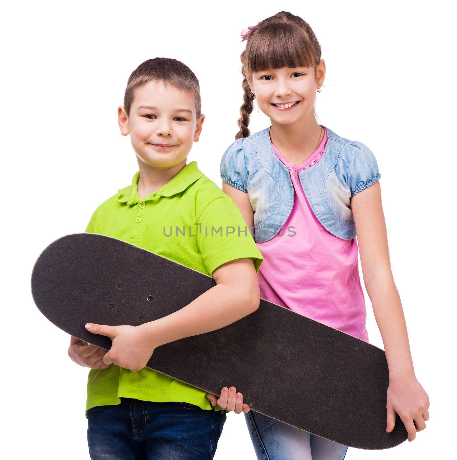 two pretty children holding skateboard in hands isolated on white background