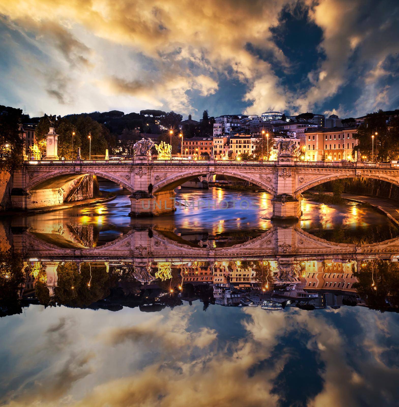 beautiful bridge in the center of Rome in the sunset with reflection in water
