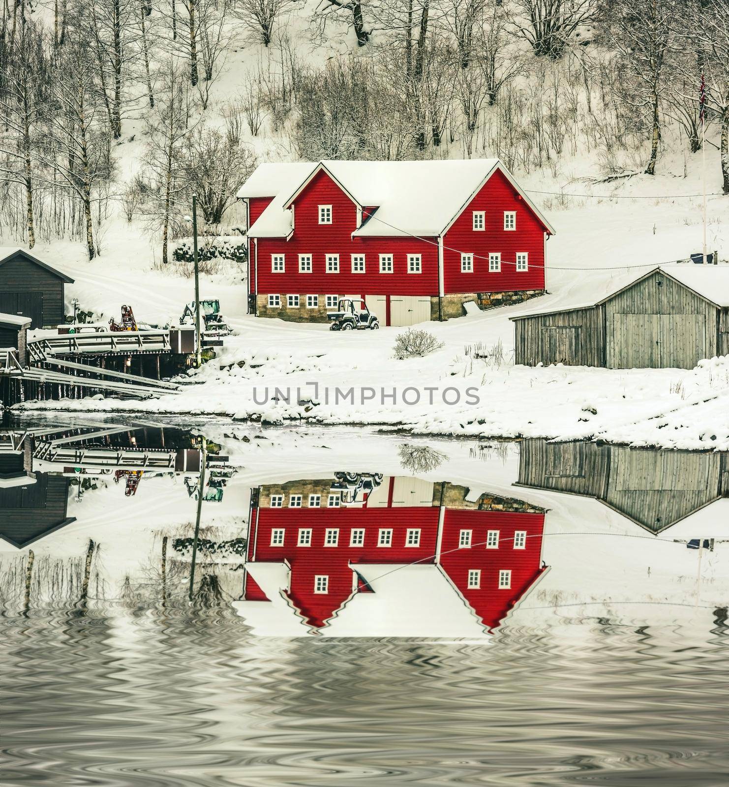 wooden houses on the banks of the Norwegian fjord with reflection in water