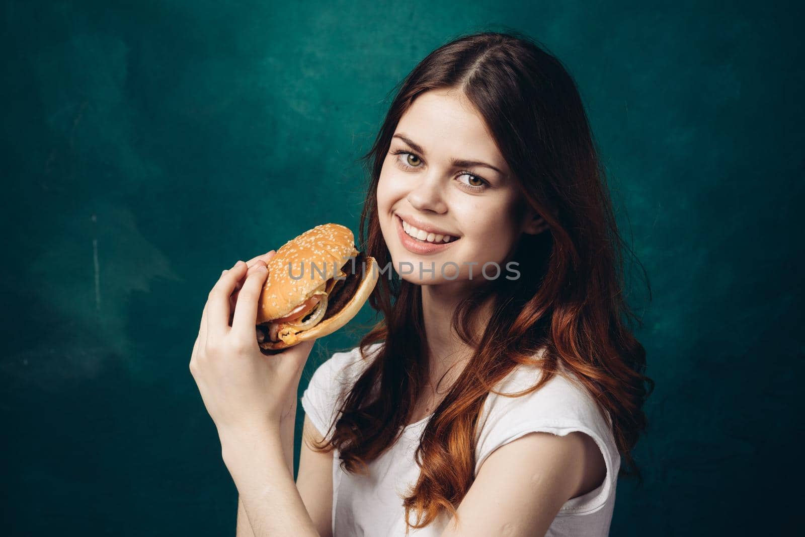 cheerful woman eating hamburger snack close-up lifestyle. High quality photo