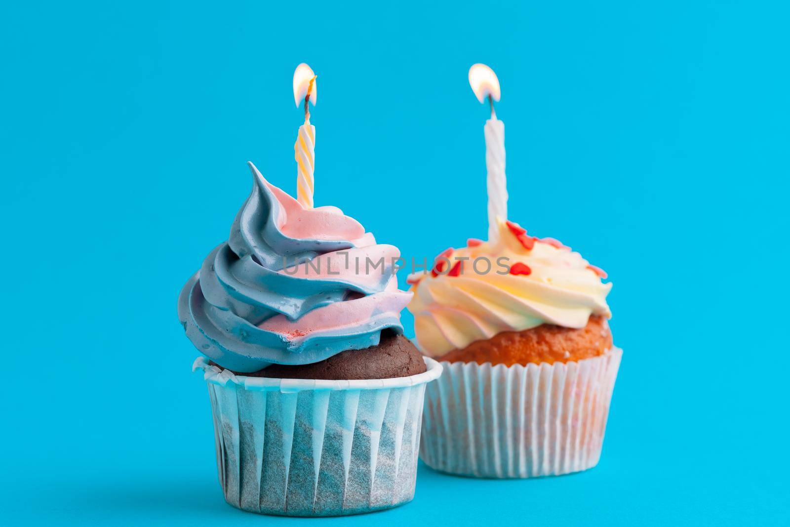 Happy birthday cupcakes on bright colored background