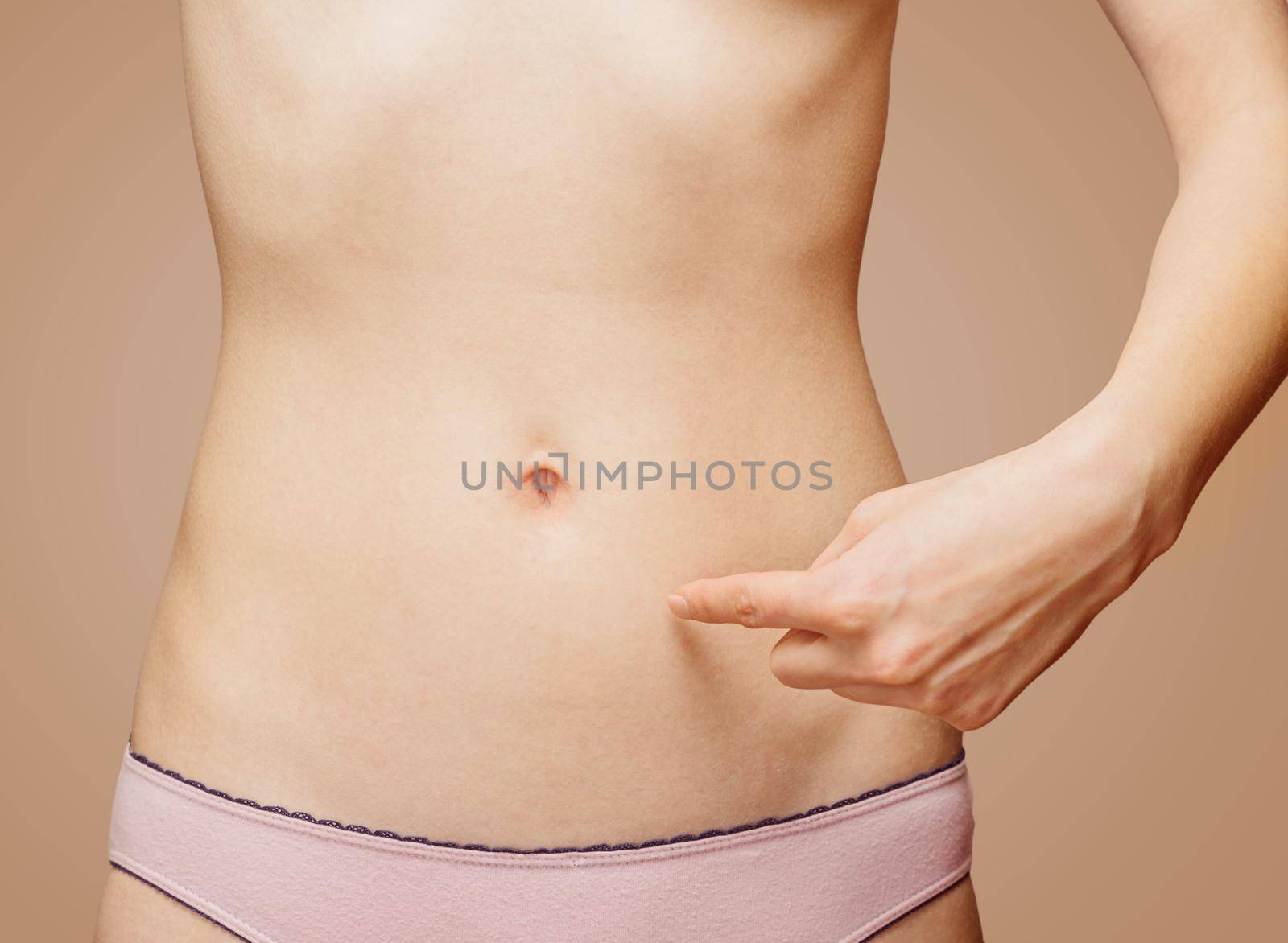 Woman points to the stomach by alexAleksei