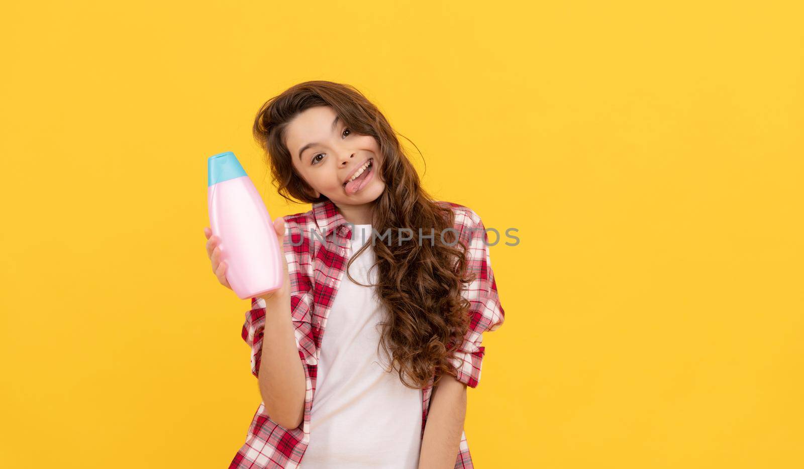 happy teen girl with long curly hair hold shampoo bottle, presenting product by RedFoxStudio