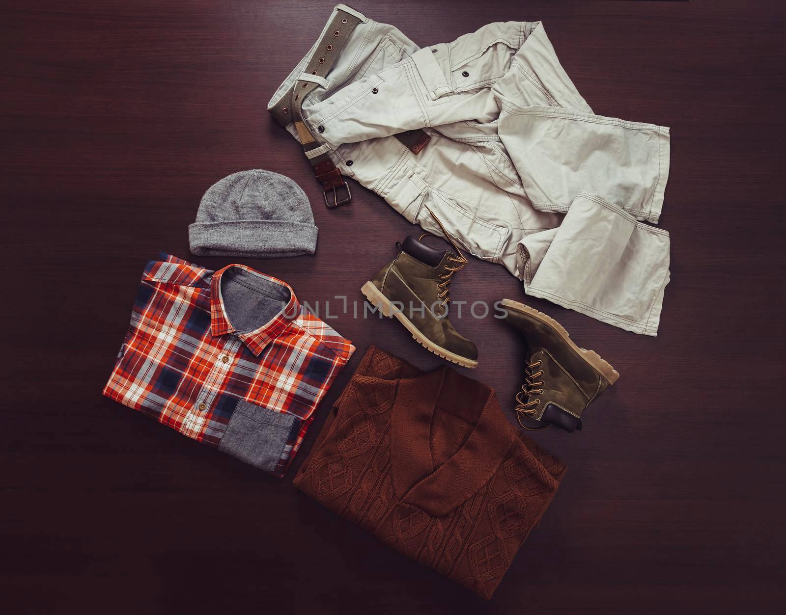 Set of fashionable male clothing in casual style on wooden background, top view