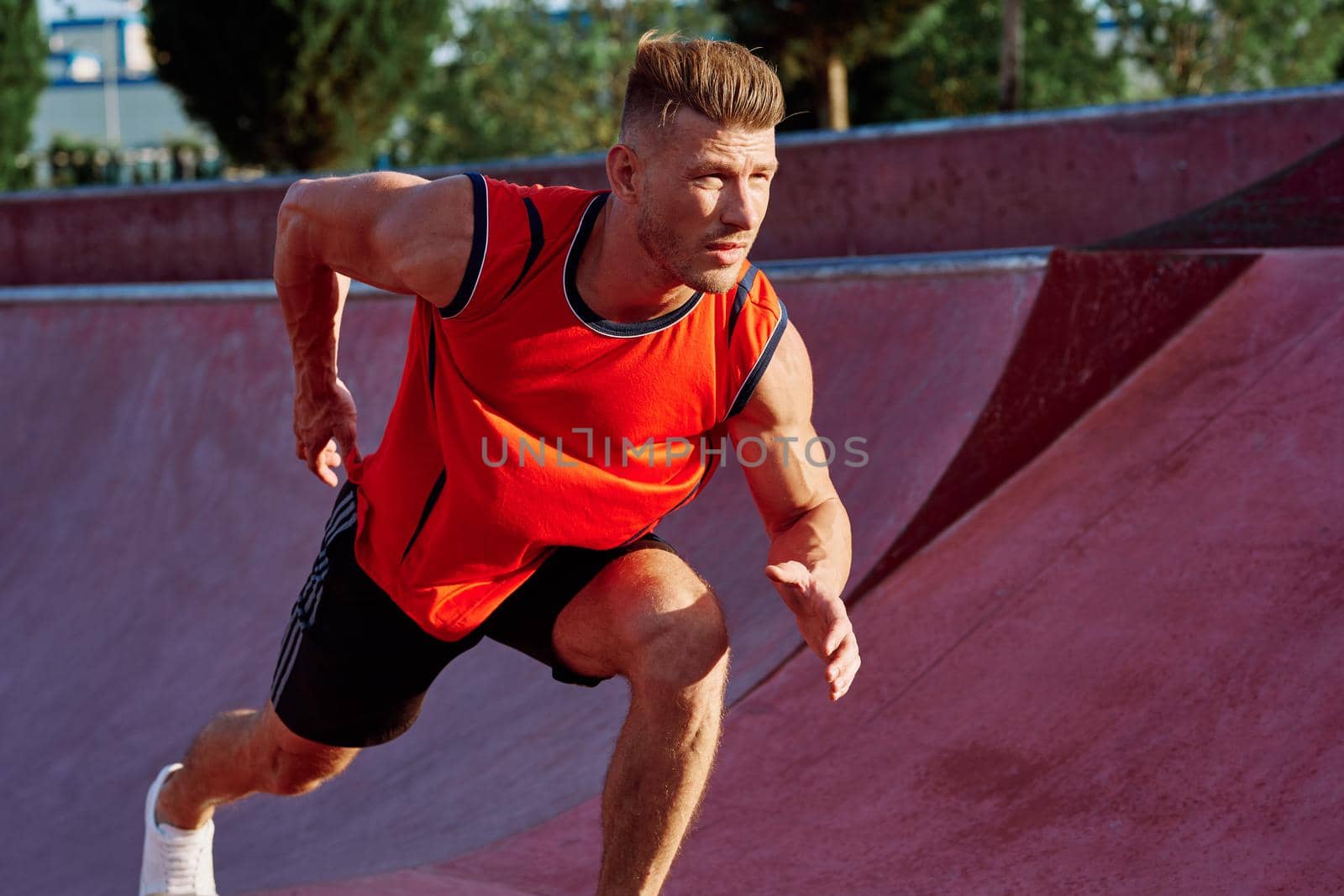 man doing exercises outdoors in the park by Vichizh