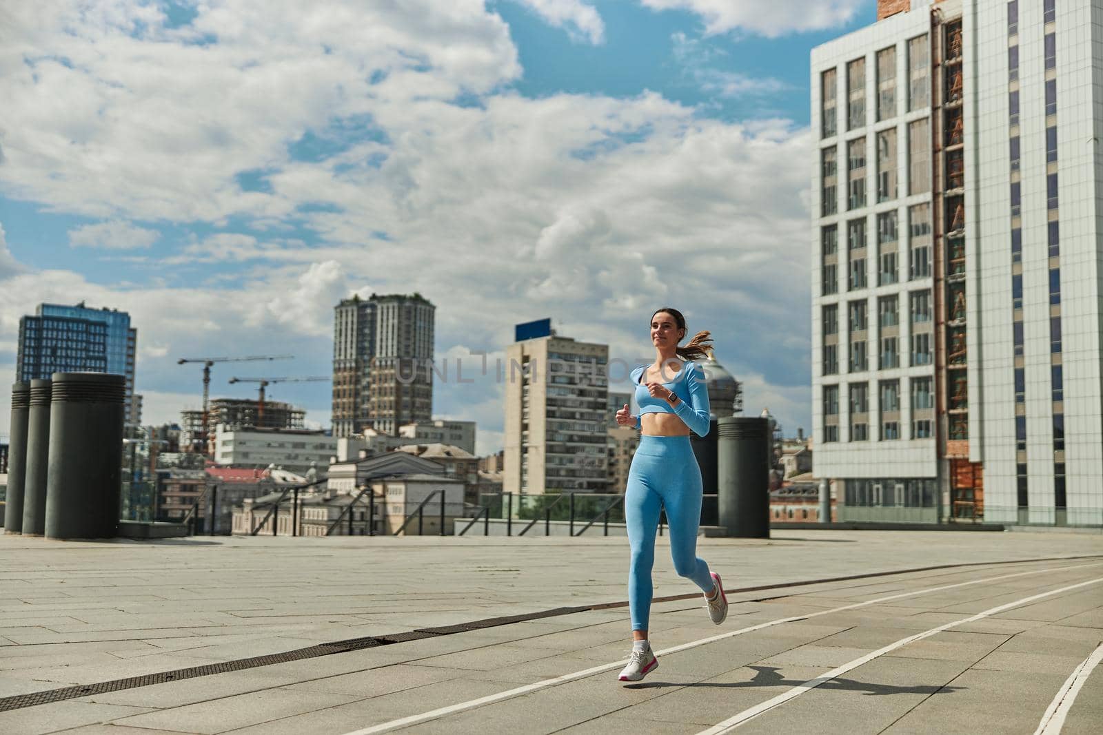 Beautiful fit young woman jogger is running outdoors