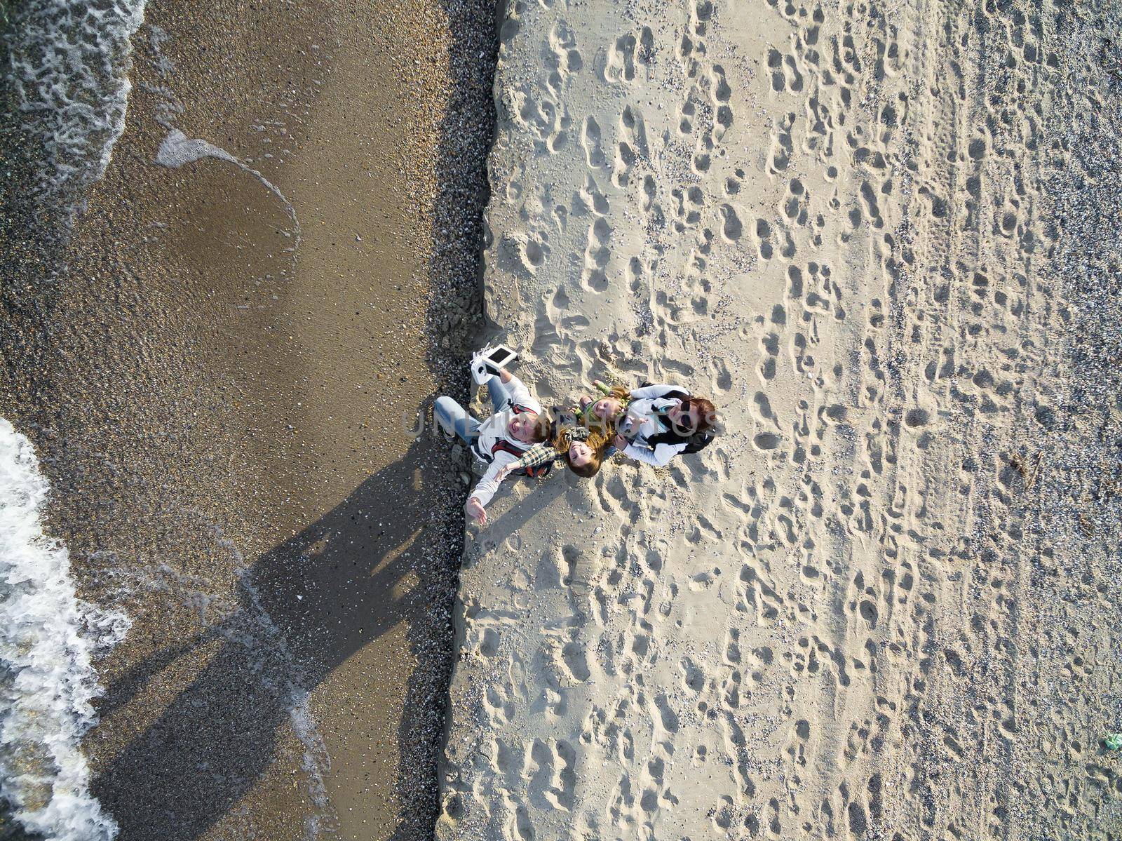 happy family walking on the beach, top view, aerial photo
