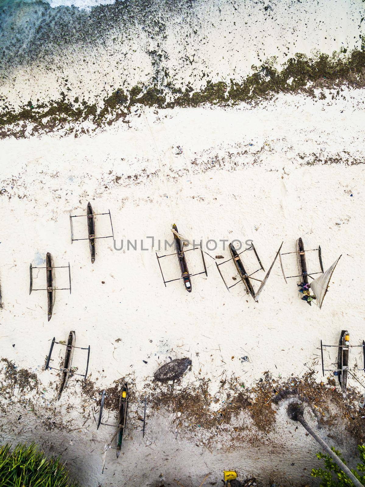 many wooden fishing boats on african seashore by GekaSkr